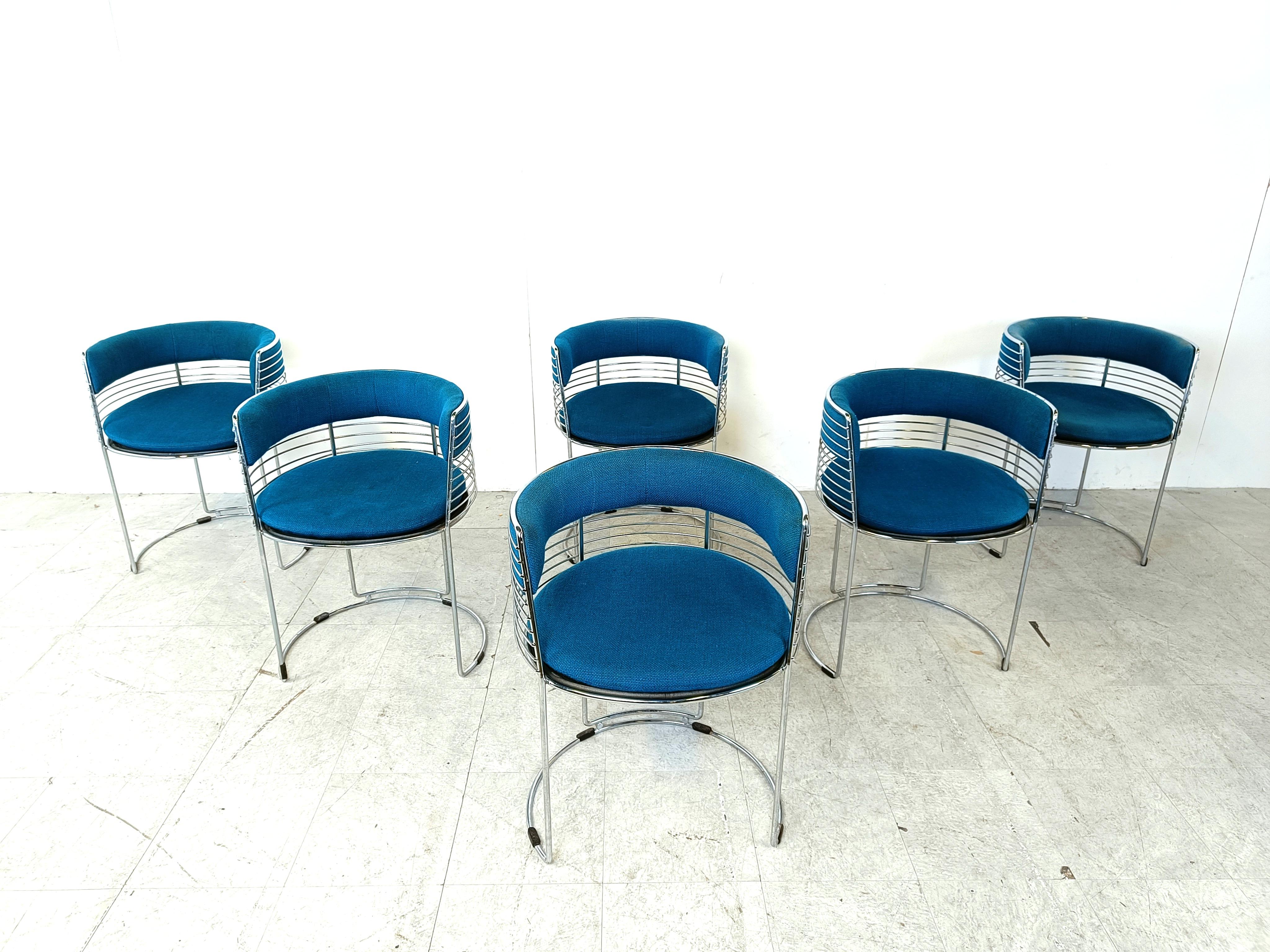 Unique space age chrome wire dining chairs with blue fabric upholstery.

The fabric is still original and contrasts well with the chromed frame.

The timeless design will fit in almost any interior and will be a talking point.

1970s -