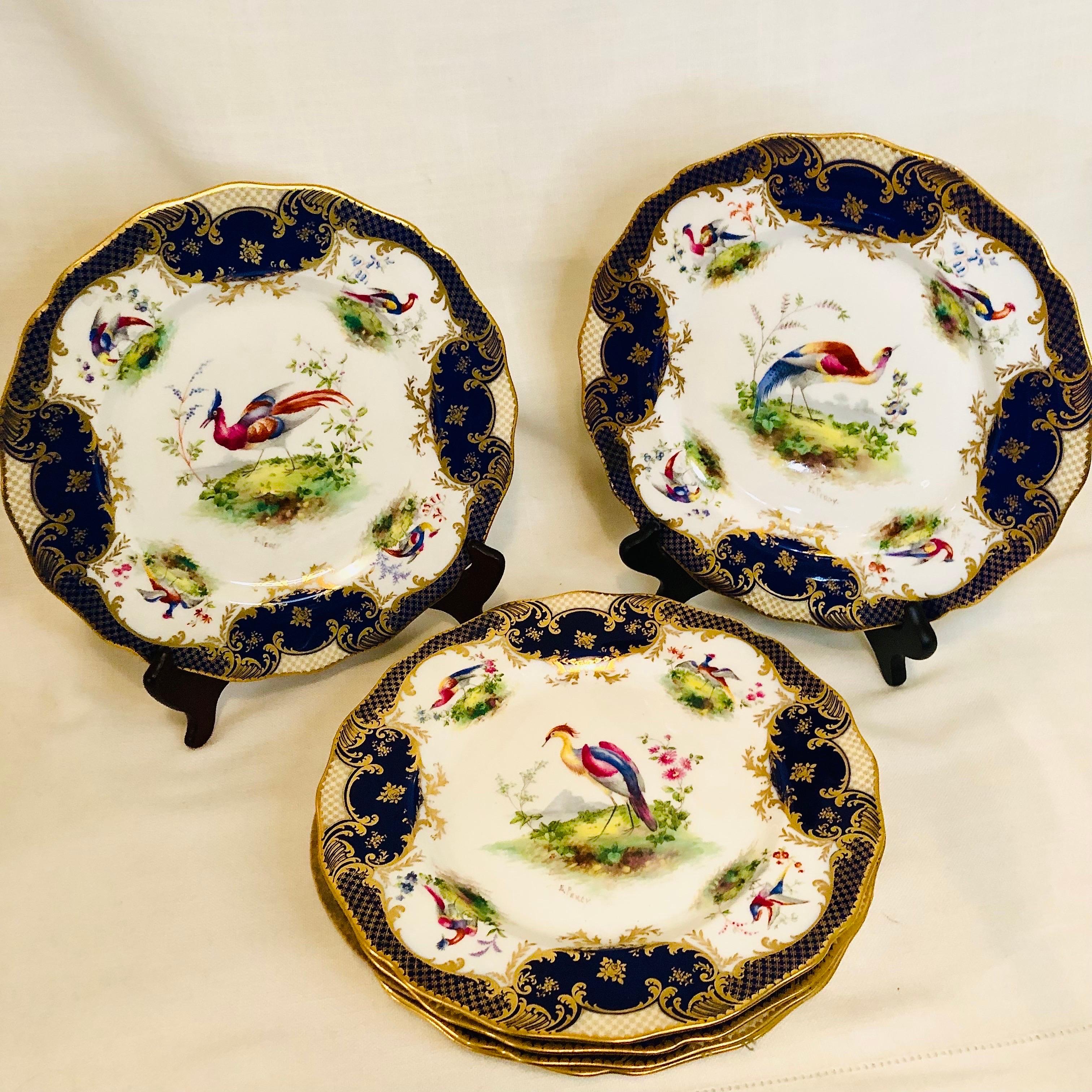 This is a fabulous set of six Royal Doulton dinner plates that were exclusively made for Tiffany and Company in New York. Each plate has a large exotic bird in the center and four cartouches of birds and flowers on a white ground inside the