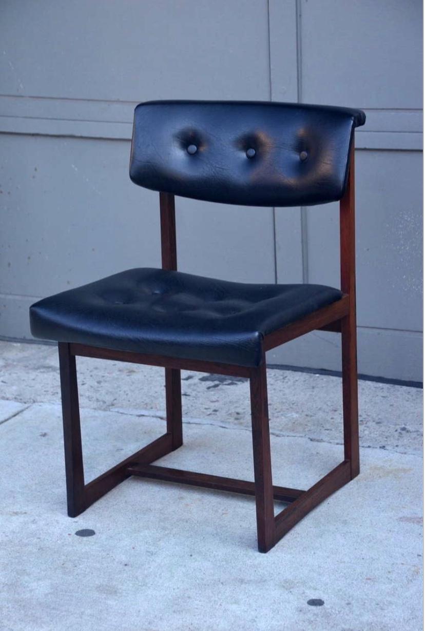 Set of 6 comfortable Brazilian rosewood chairs. Sturdy angled Brazilian rosewood frames, original black vinyl upholstery.
