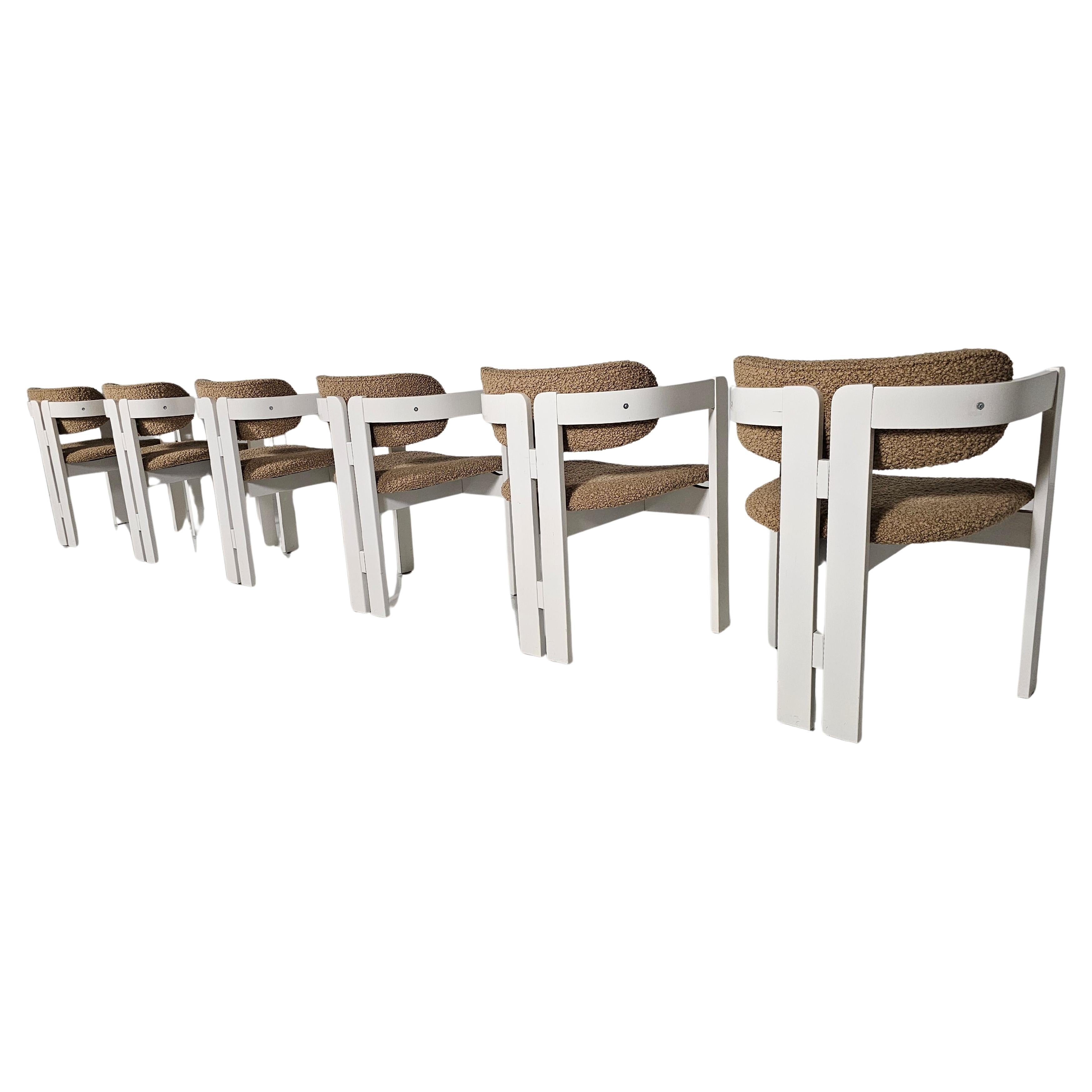 Set of 6 Pigreco style dining chairs from Italy, 1970s.

The beechwood frame is cream white lacquered in the past and shows minor signs of age, while the seat and back are new upholstered with a beige boucle.

The chairs have a gently rolling line