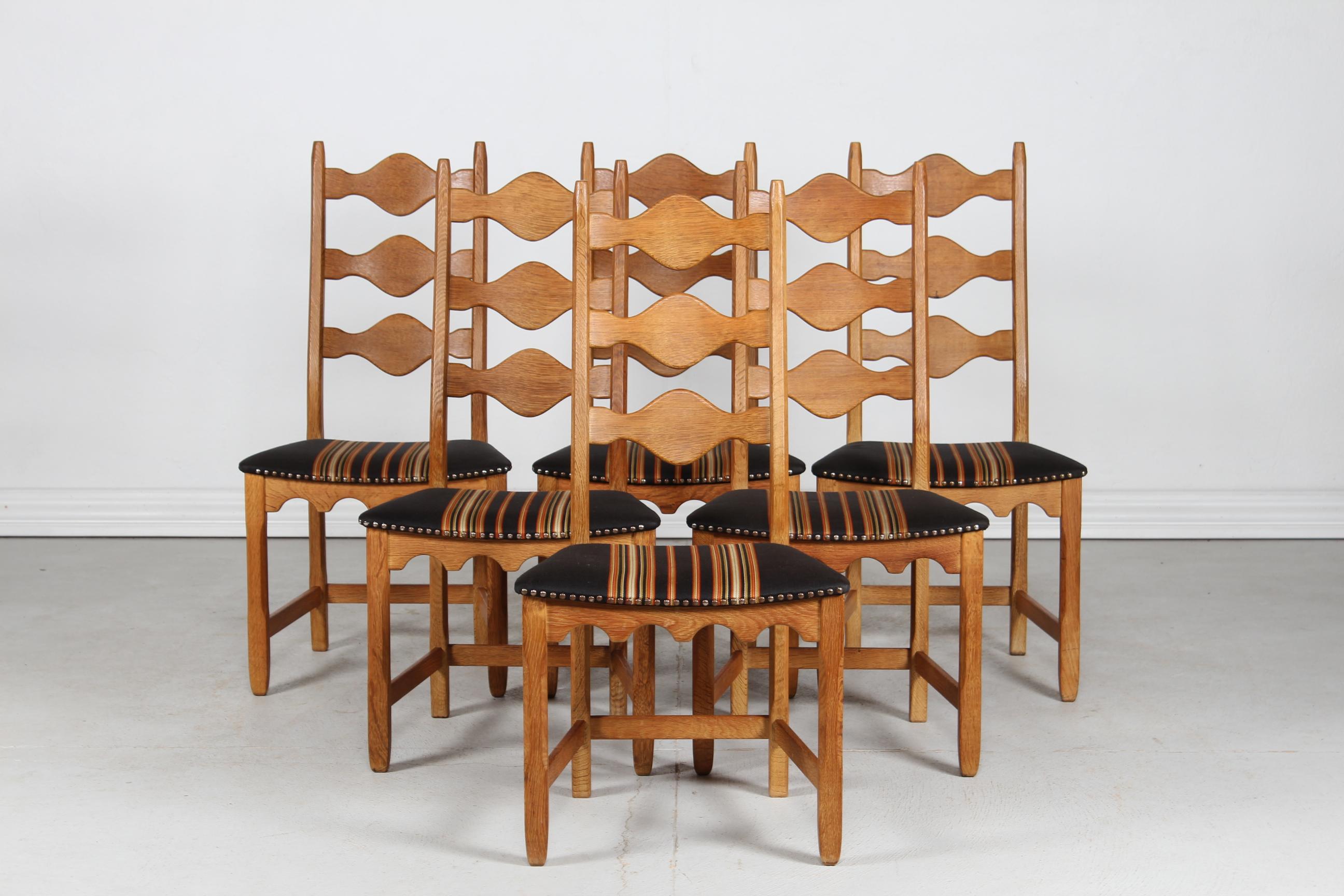Here is a set of 6 Danish vintage chairs in great country style. 
They are designed by Henning Kjærnulf and manufactured by the Danish company Nyrup Møbelfabrik/ EG Furniture.
The chairs are made of solid oak with high backrest. 
The seats are