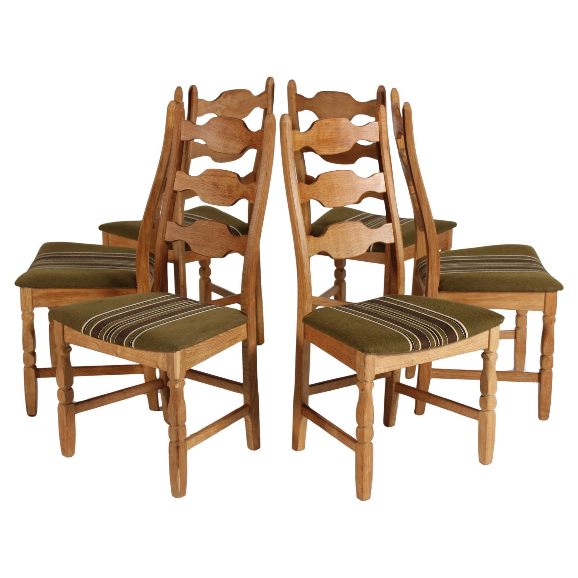 Here is a set of 6 Danish vintage high back rest razor blade chairs in great country style. 
They are designed by Henning Kjærnulf and manufactured by the Danish company Nyrup Møbelfabrik/ EG Furniture.
The chairs are made of solid oak with great