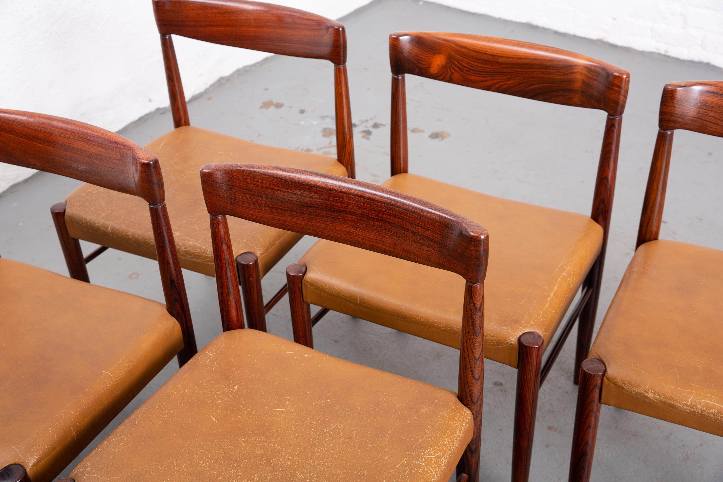 Set of 6 Danish Mid-Century Modern curved back dining chairs with tapered tubular legs and beautiful wood. Original leather upholstery with great patination and age to the leather. Wood in original condition with minor wear to limited areas. Sturdy.