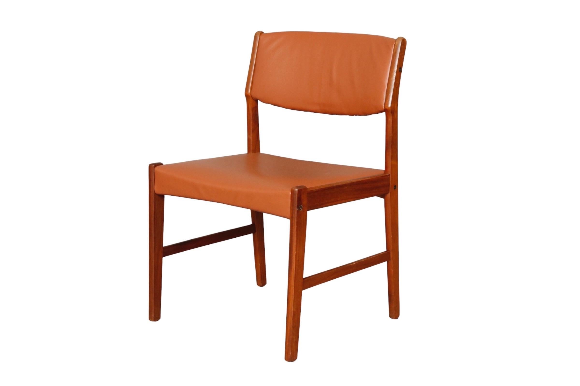 Set of 6 Danish dining chairs in a classic mid century shape. Frames are made of teak with square seats and wide scoop backs upholstered in a cognac colored vinyl.