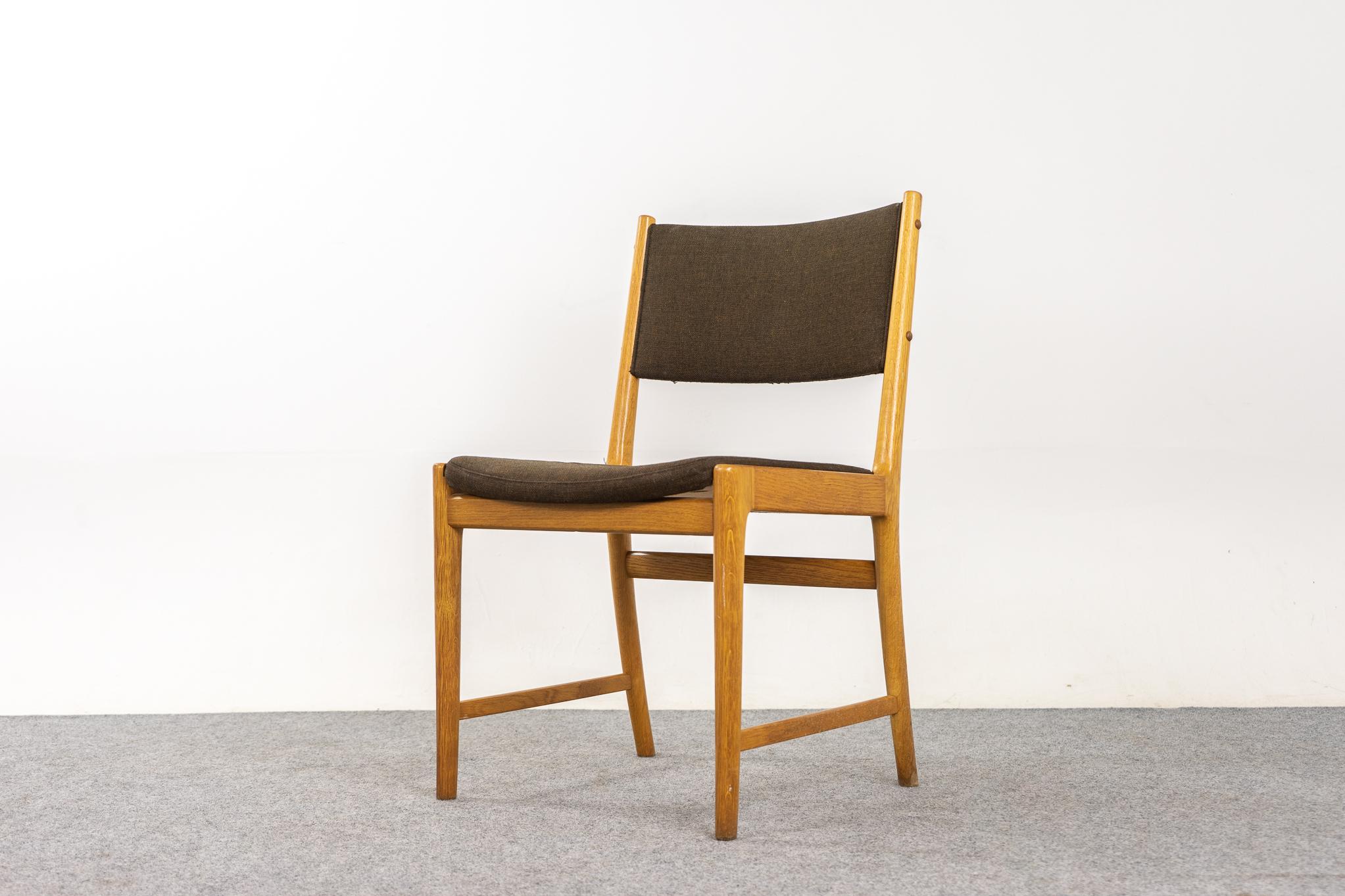 Oak Danish modern dining chairs by Kai Lyngfeldt Larsen, circa 1960's. Beautifully curved backrests and generous seat design provide support and comfort. Solid wood frame with beautifully wood grain. Cross braces add stability and support for years