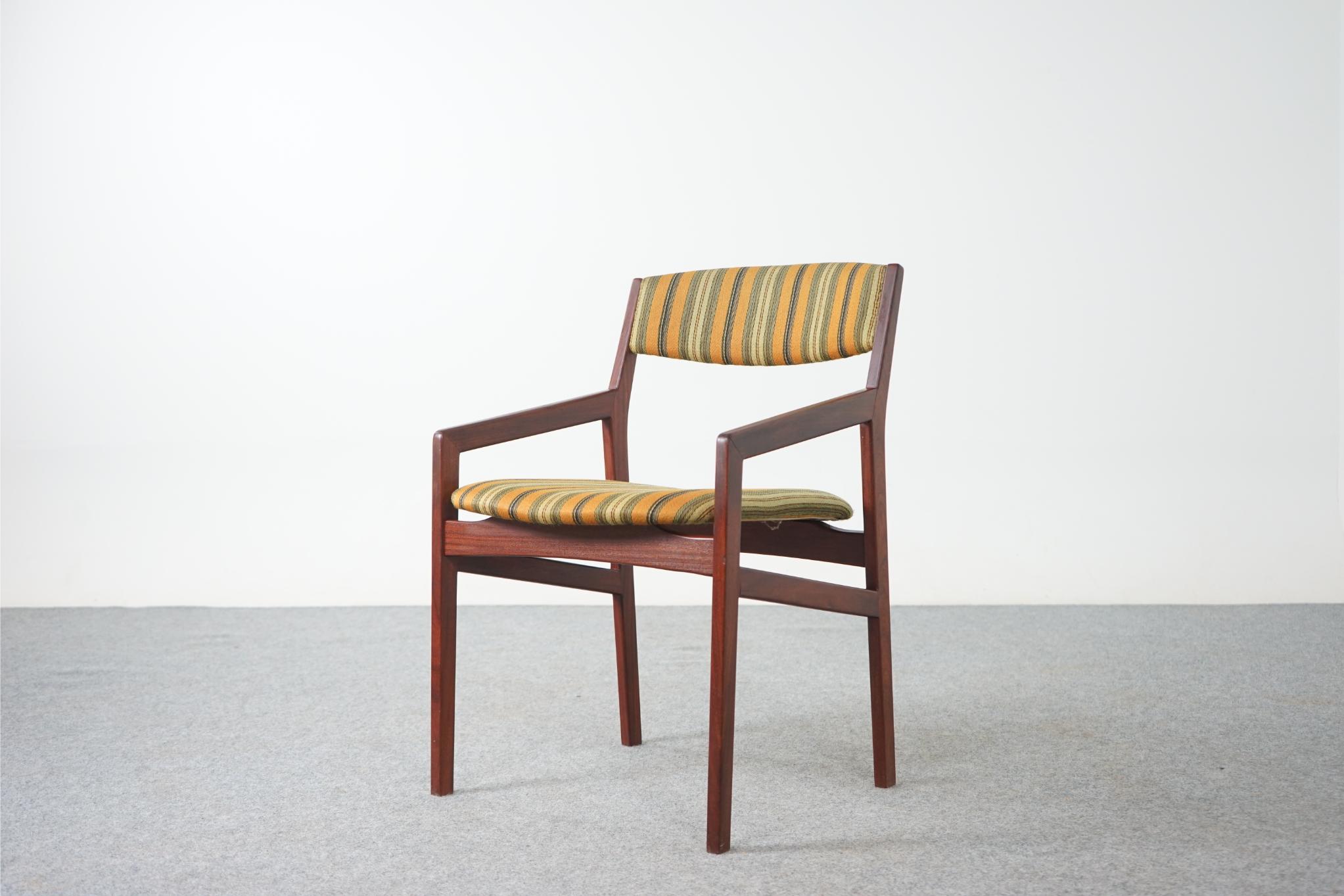 Teak Danish dining chairs, circa 1960's. Solid Afromosia frames feature cross braces for added stability and support. Floating seat design adds an air of lightness and elegance to the frame. Low arms create a charming geometric silhouette. Original