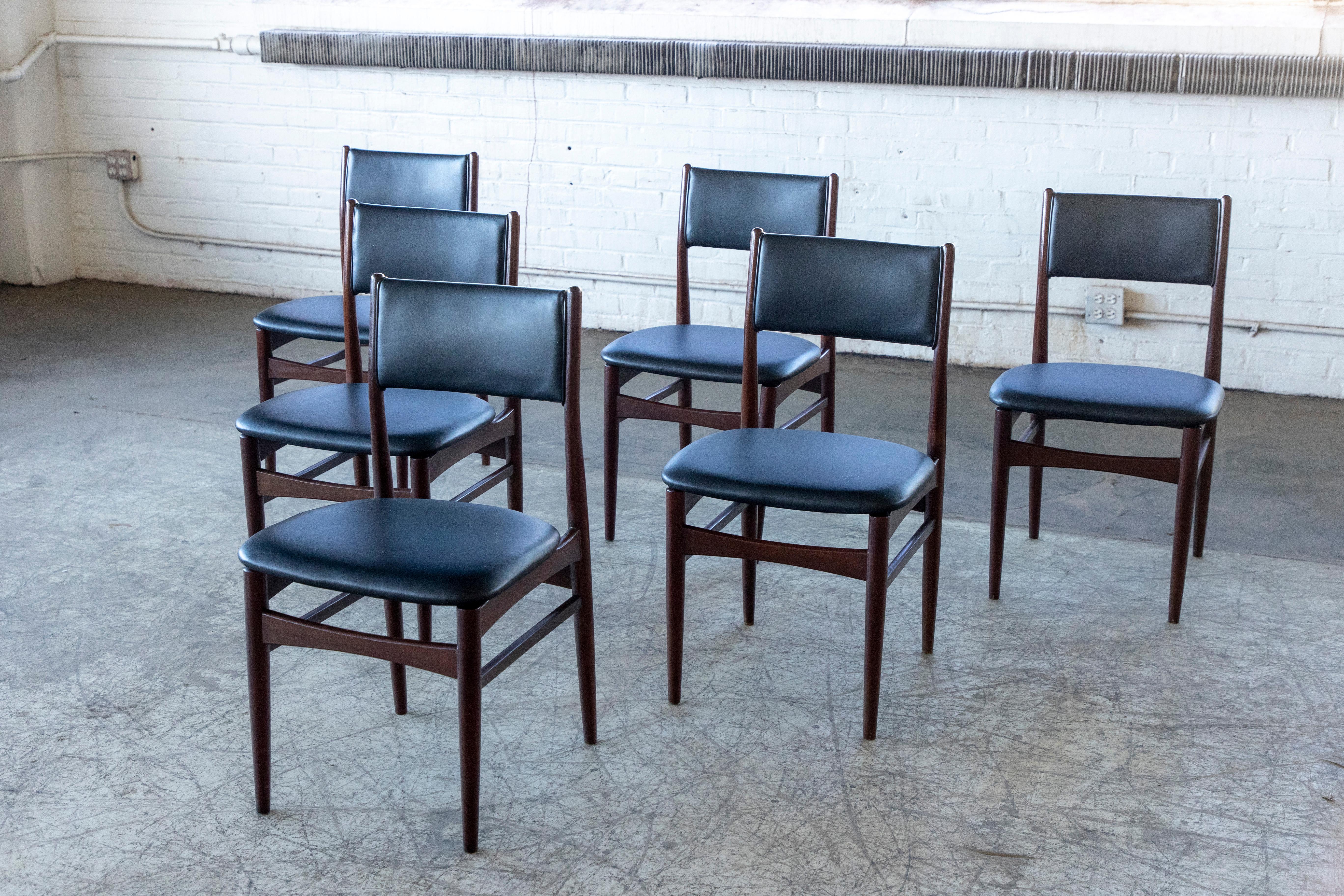 Set of six very stylish and traditional Danish midcentury dining chairs in the style of Erik Buch. Nice slim silhouette and beautiful in their simple yet refined lines. Made in the 1960's from teak and later recovered in black leather. Overall very