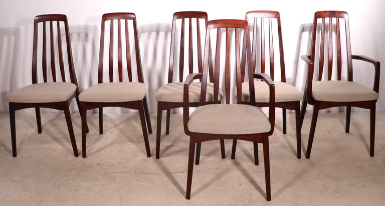 Chic set of six dining chairs by noted Mid Century Danish manufacturing company Skovby Mobelfabrik. The set includes two arm, or captains chairs, and four side chairs. All are in very good original condition showing only light cosmetic wear normal