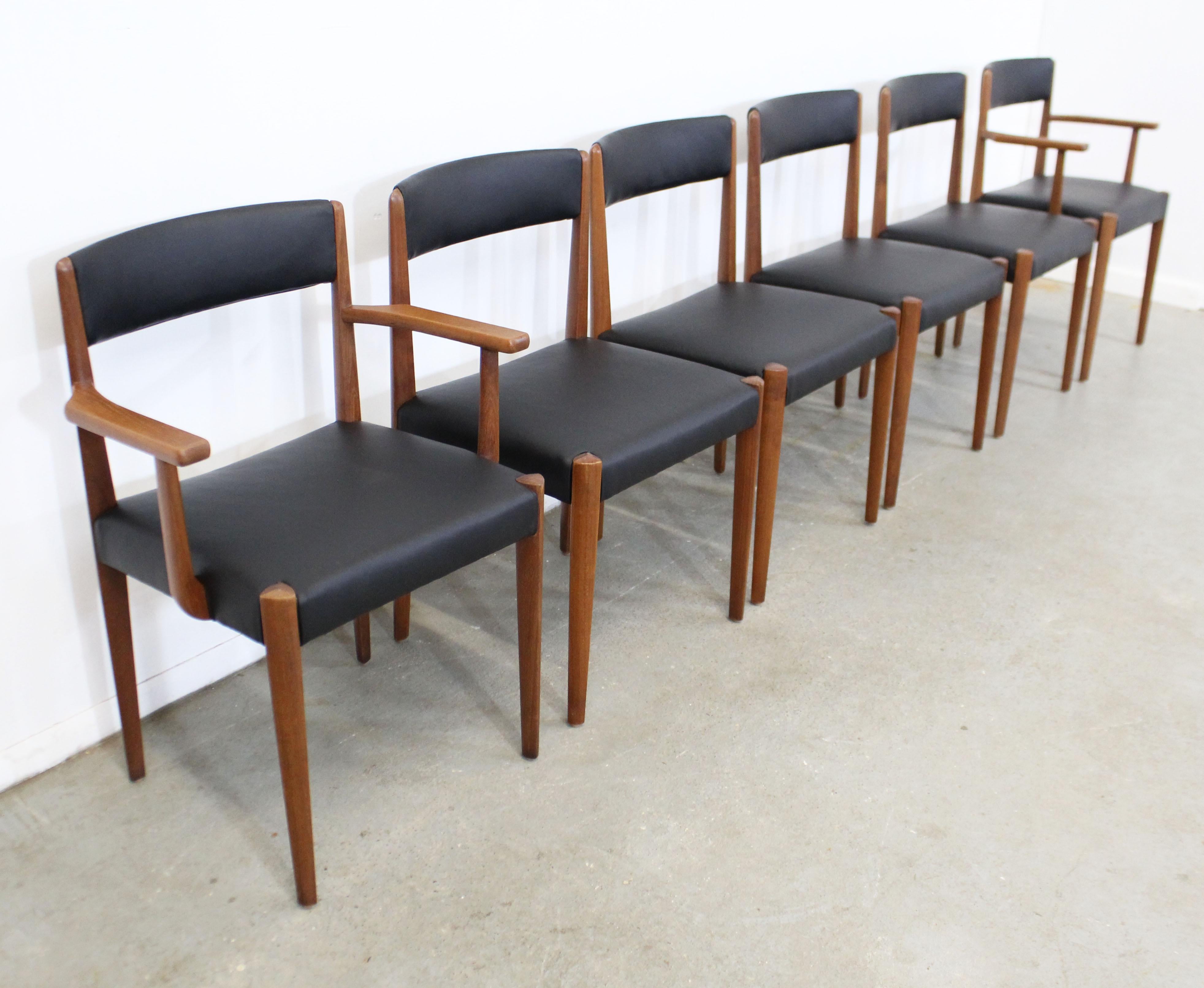 What a find. Offered is a restored vintage set of 6 rare, sleek Danish modern dining chairs. These chairs are made of teak, have been refinished and reupholstered in a supple black leather. They are in excellent restored condition, structurally