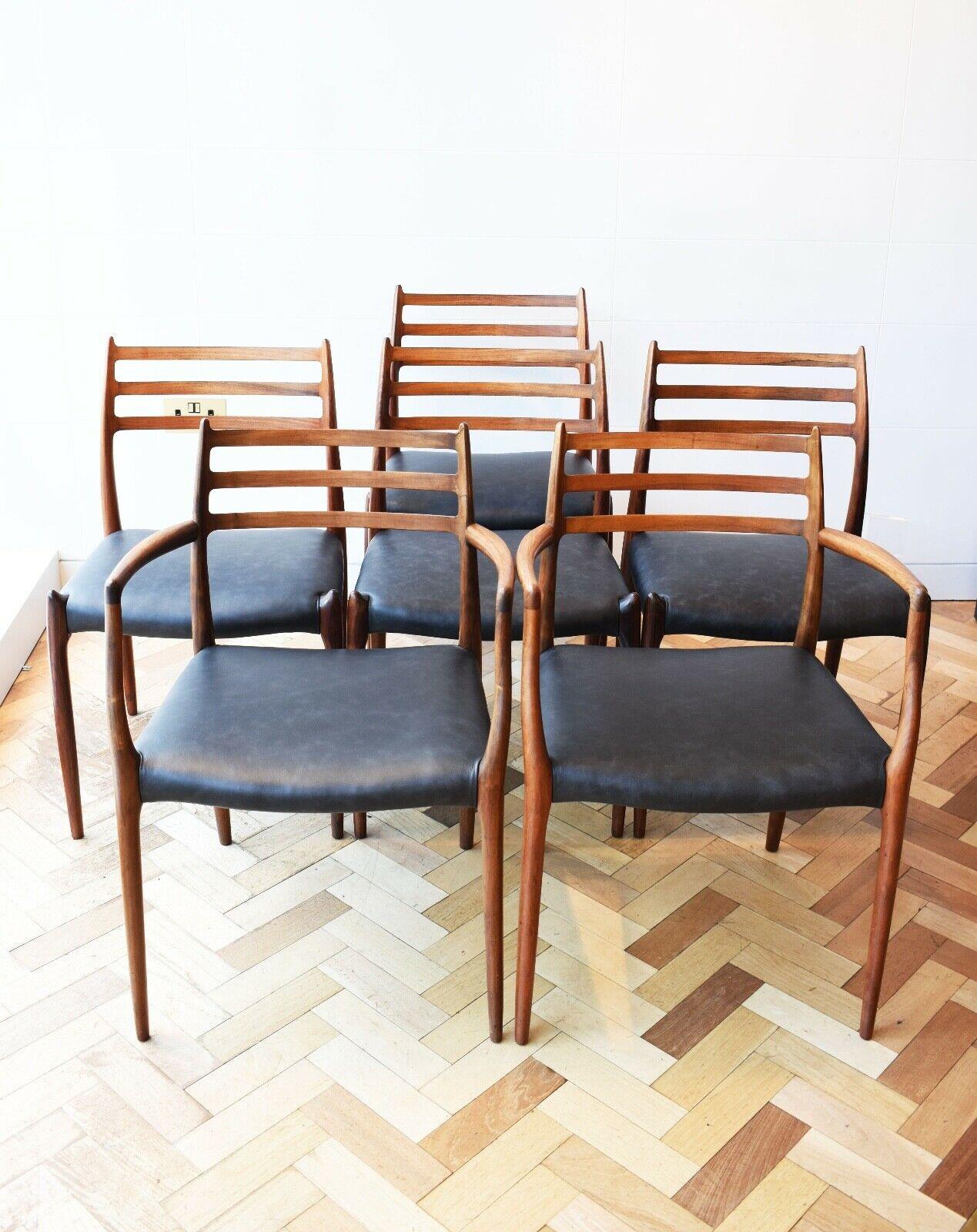 A stunning set of 6 Danish dining chairs with black leather seats and Rosewood frames, Model no. 78s. Circa, 1950s. 

These elegant dining chairs were designed by Niels Otto Moller for the Danish manufacturer J.L. Moller.

This super stylish &