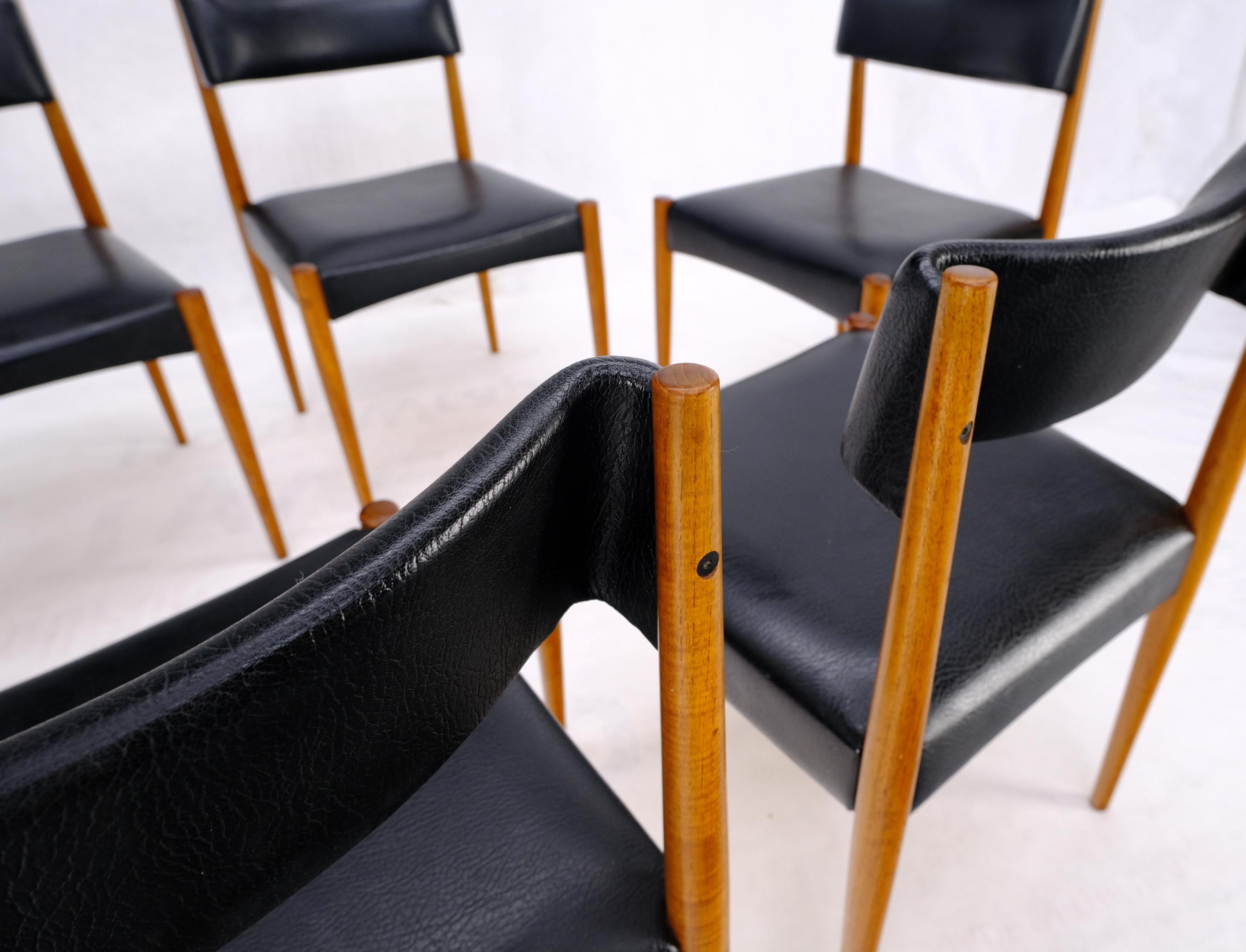 Set of six mid century modern danish teak dining chairs in black leather upholstery. Beautiful molded wrap around backs.