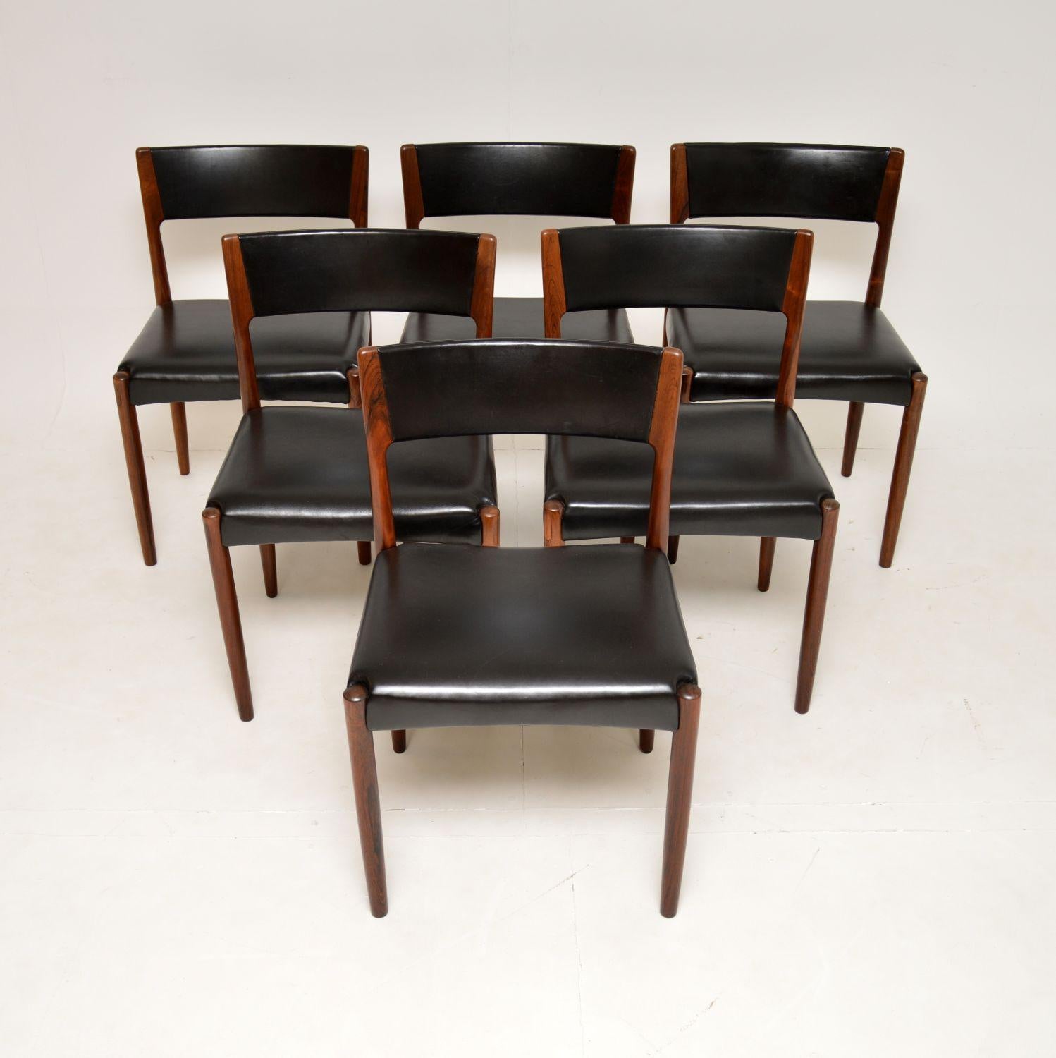 A stunning set of Danish dining chairs with black leather upholstery. They were designed by Harry Ostergaard and were made by Randers in the 1960’s.

They are of exquisite quality, with a beautiful design and gorgeous grain patterns. They are very