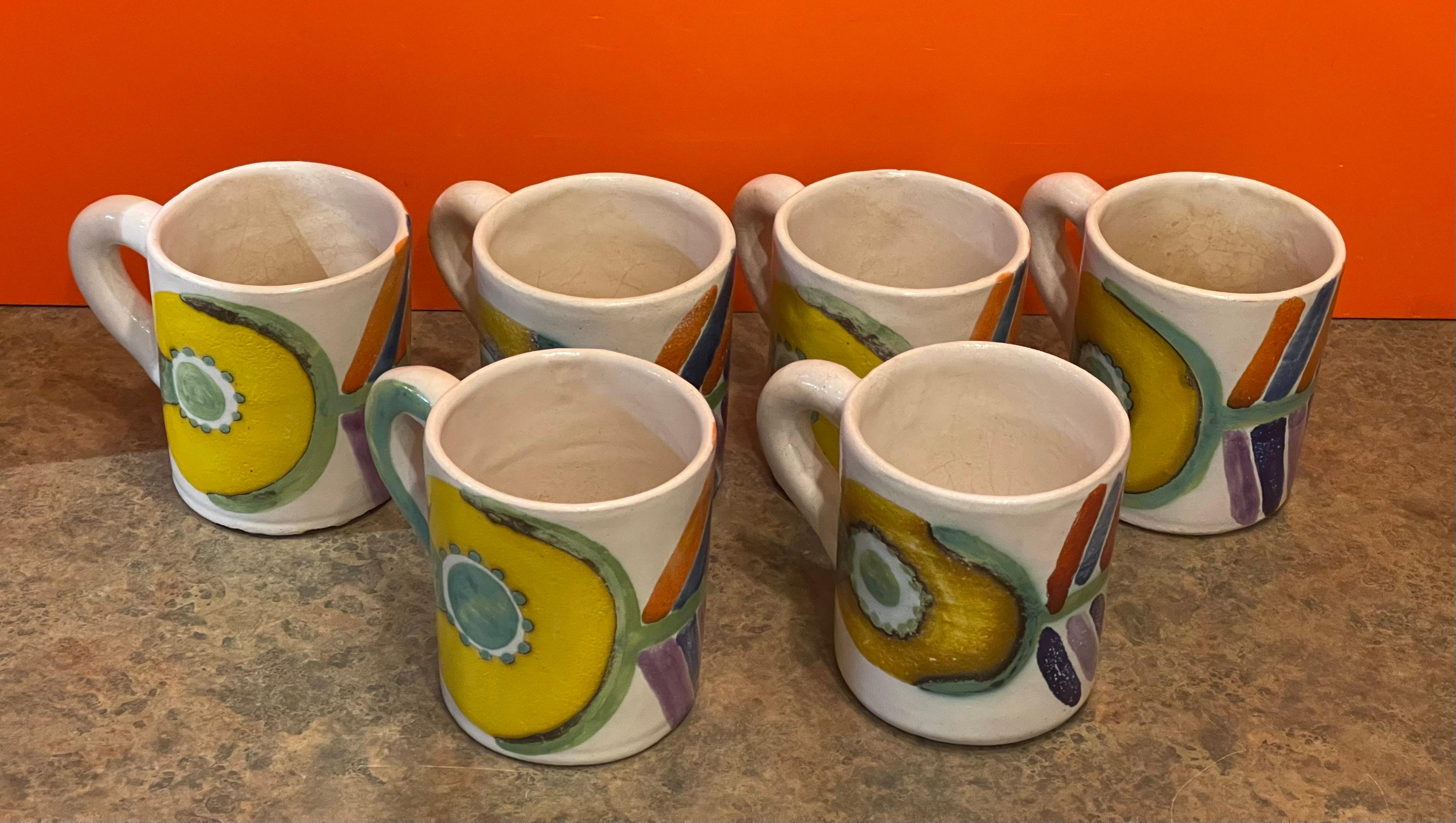 Set of 6 decorative hand painted Italian pottery mugs by DeSimone, circa 1960s. The mugs are in good vintage condition with a few small chips, some crazing and some discoloration to the inside of the mugs from coffee (please see pictures). They are
