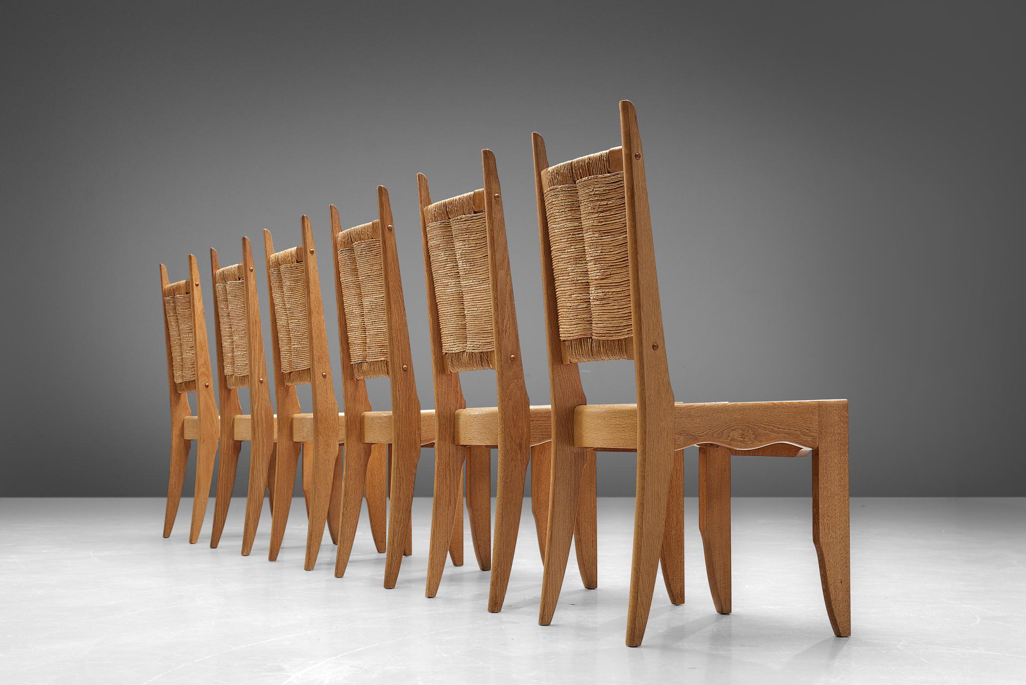 Guillerme & Chambron for Votre Maison, set of 6 dining chairs, solid oak and rush seating, France, 1960s.

Set of six dining chairs in solid oak and rush by Guillerme and Chambron. These chairs show the characteristic frame of this French designer
