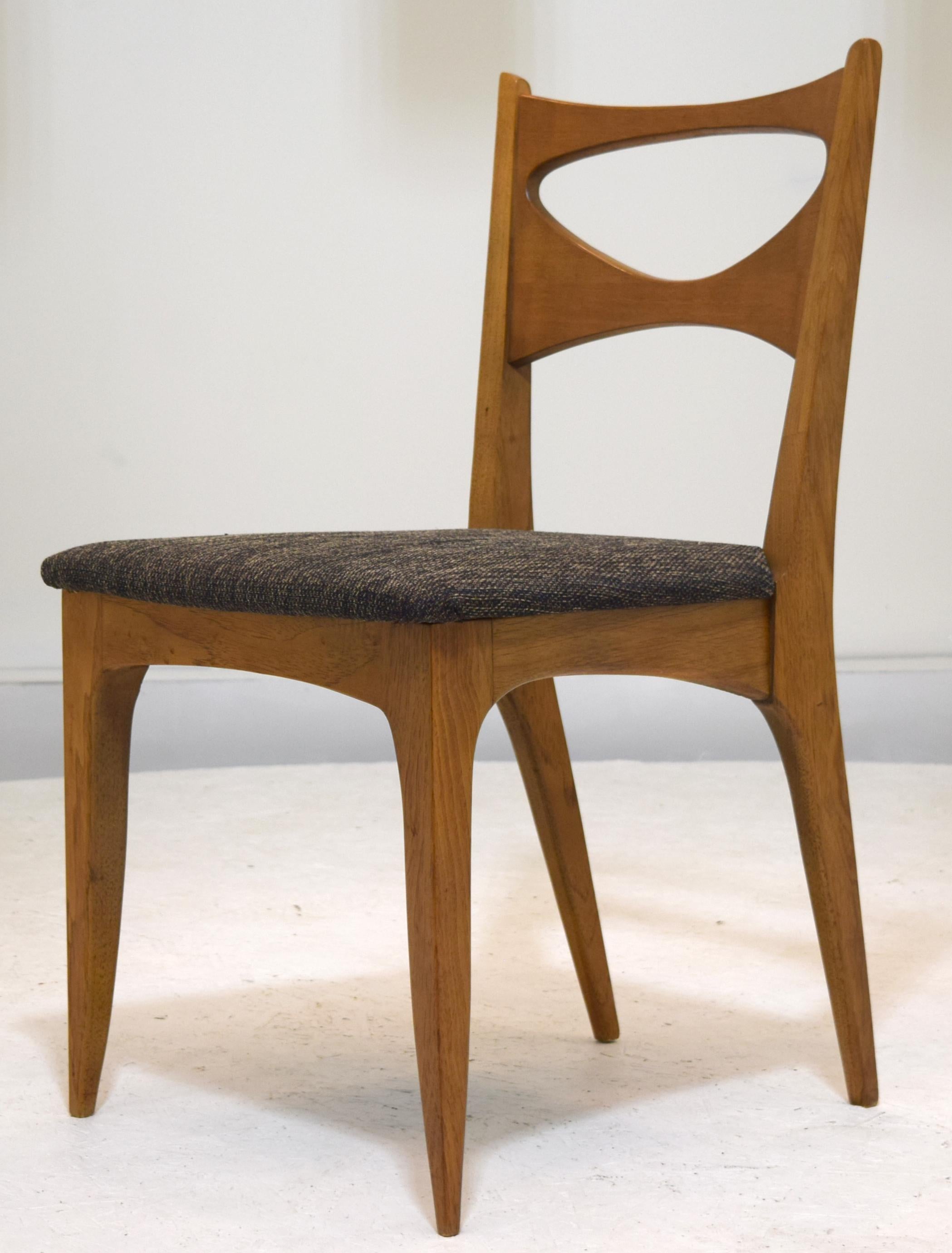 Of solid walnut construction with sculpted backs is a set of six dining chairs for the Drexel Profile series, designed by John Van Koert, Model K62. Note the original walnut has a lighter tone which highlights the grain wonderfully. This patina is