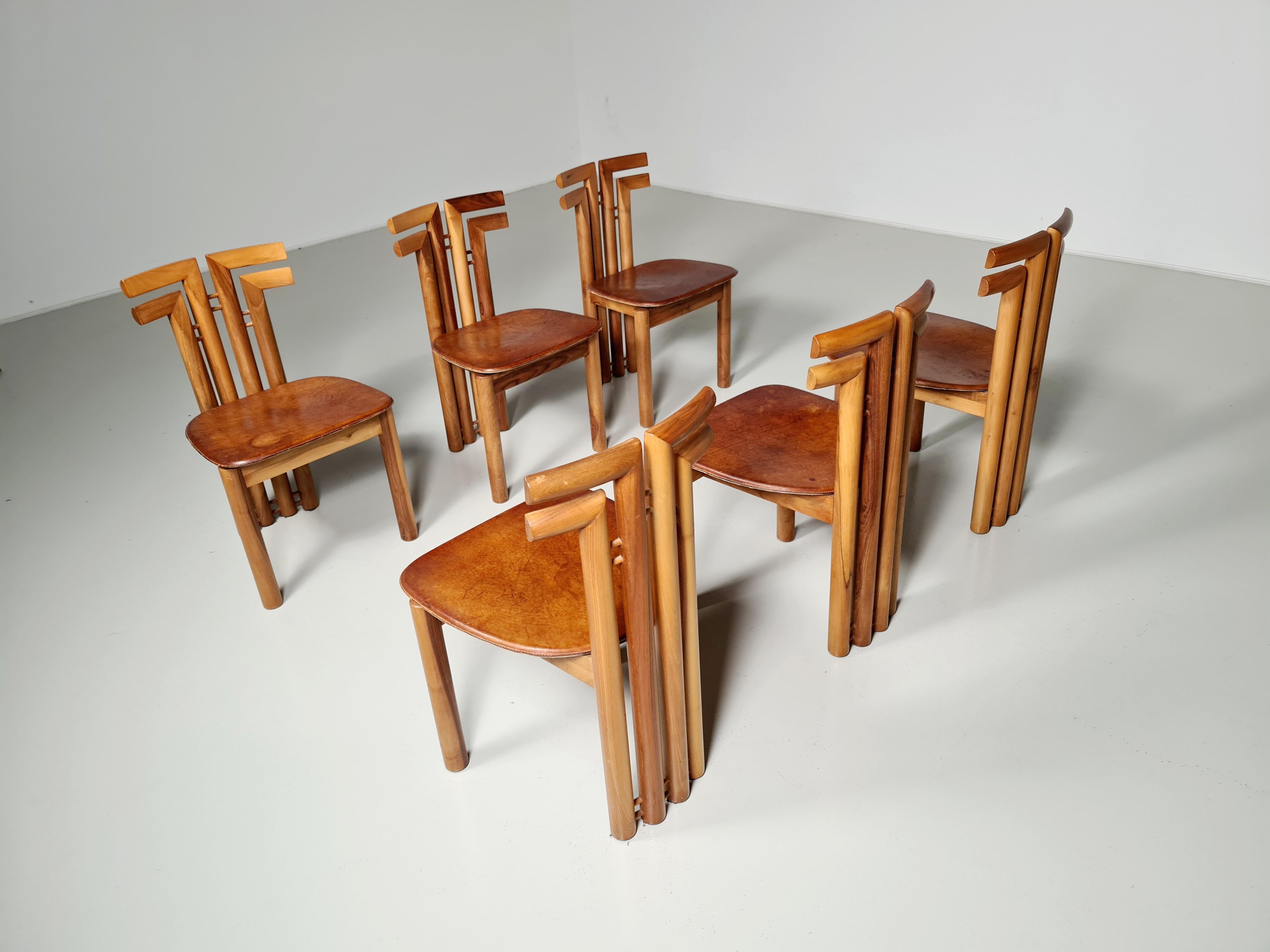 Sapporo for Mobil Girgi, set of six dining chairs, Italian walnut and black leather, Italy, 1970s. Sculptural chairs by Sapporo Mobilgirgi that feature wonderful backrests. The color of the Italian walnut frame is deep and warm which accompanies the