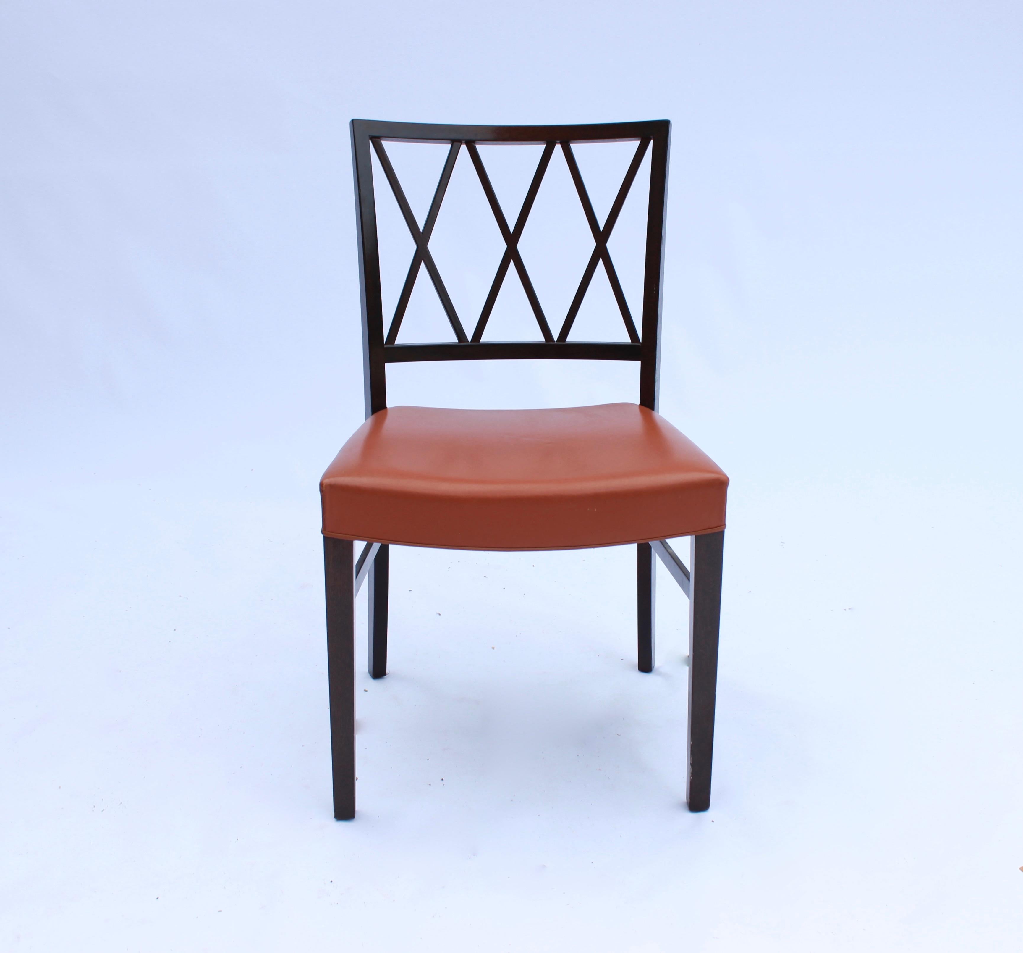 Set of 6 dining chairs in dark mahogany and cognac colored leather designed by Ole Wanscher from the 1960s. The chairs are in great vintage condition.