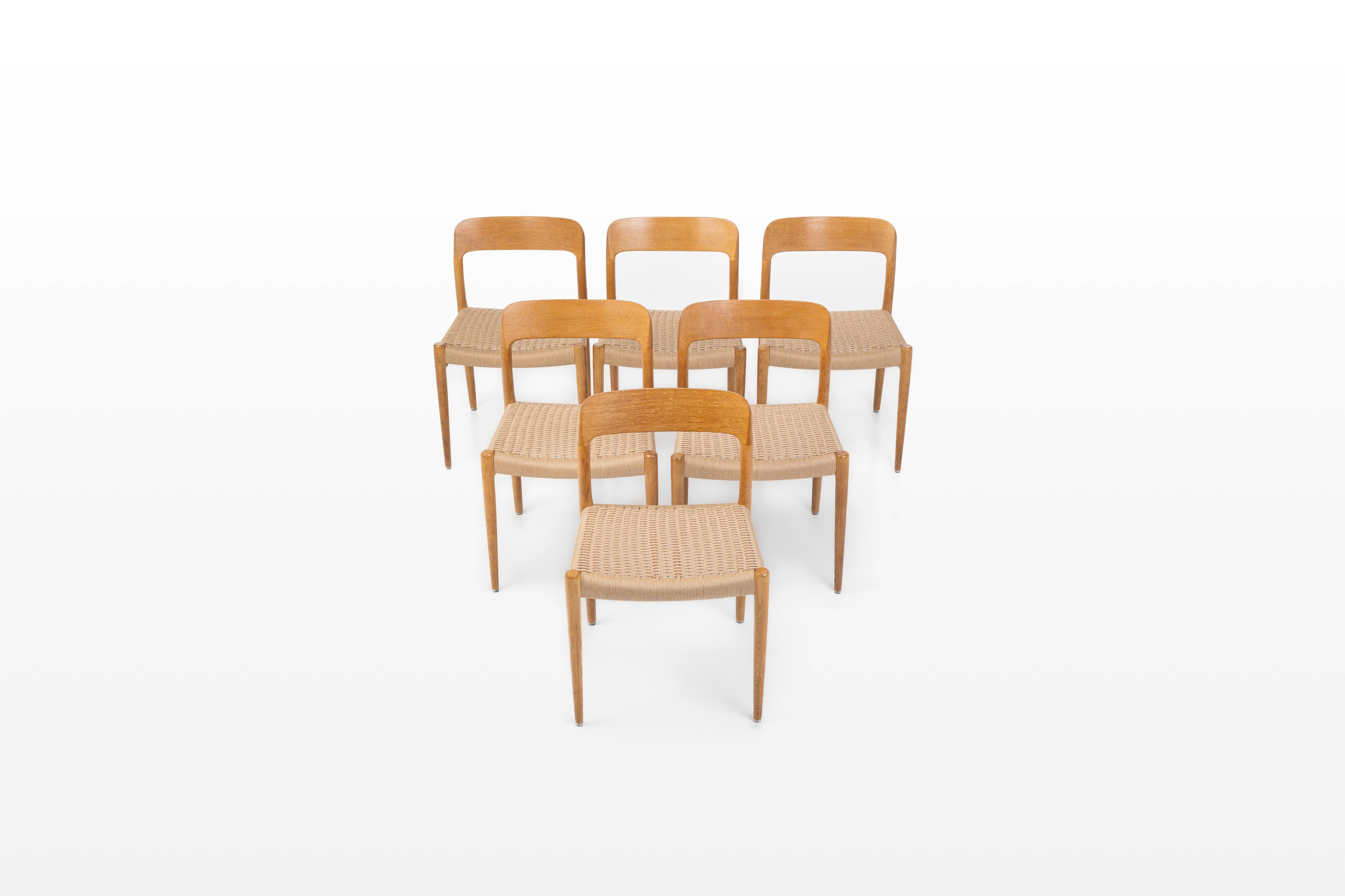 Set of six 'Model 75' dining chairs designed by Niels Otto Møller for J.L. Møllers Møbelfabrik, Denmark 1960s. The chairs have an oak frame and a papercord seating. The chairs are marked by the producer and are in very good