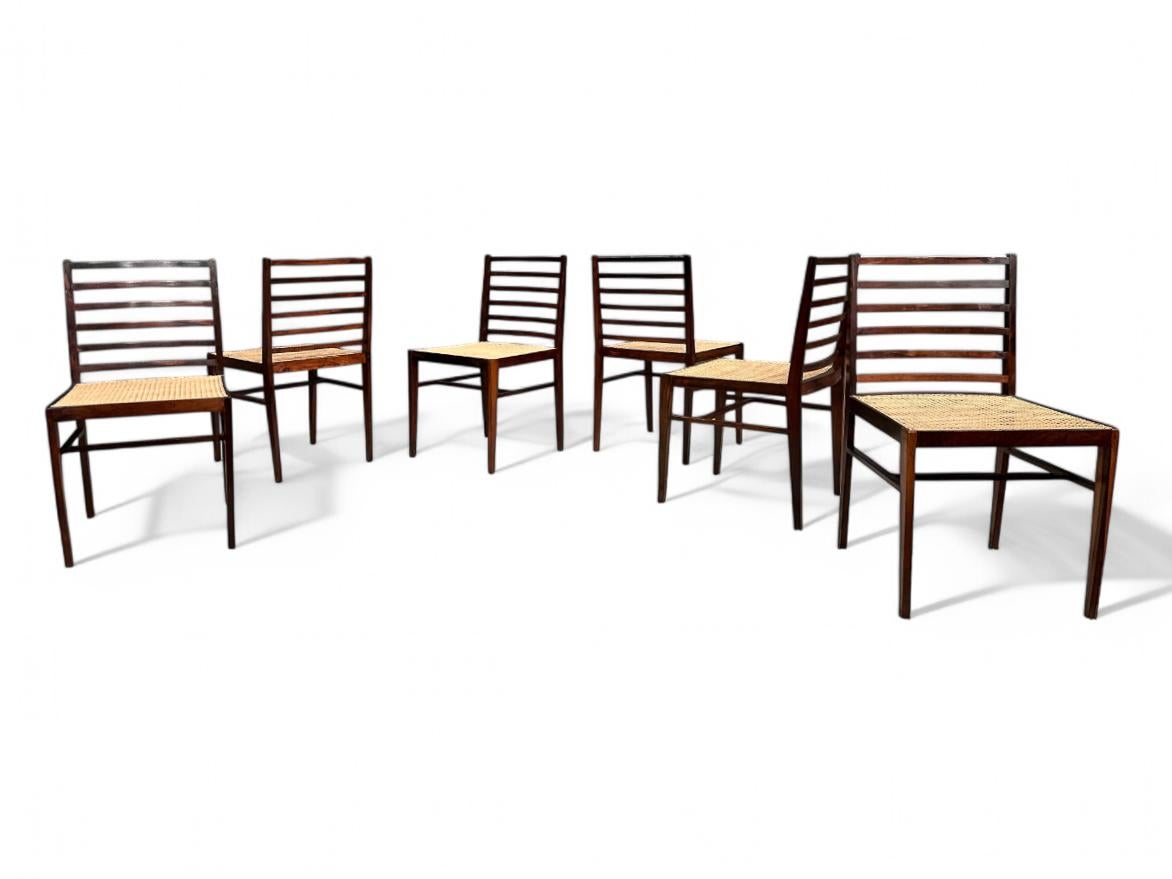 Available today, this set of 6 Dining Chairs in Rosewood & Caning, attributed to Joaquim Tenreiro made in the 1960s is absolutely magnificent!

This set of six dining chairs showcases a Brazilian rosewood frame paired with cane seats, blending