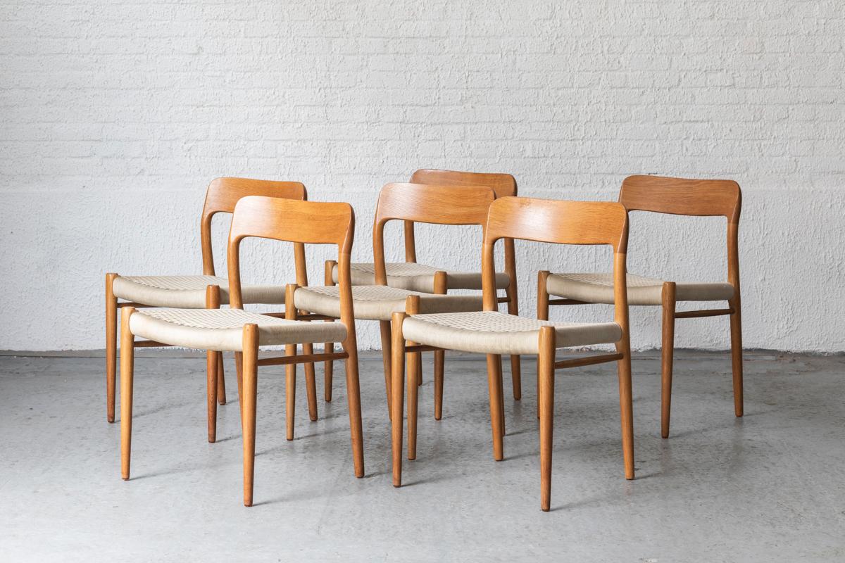 Set of 6 ‘Model 75’ dining chairs designed by Niels Otto Moller for J.L. Moller, produced in Denmark in the 1950’s. The frame is made out of  high quality oak wood, combined with a seat of woven ribbons. The weaving shows some wear such as slight