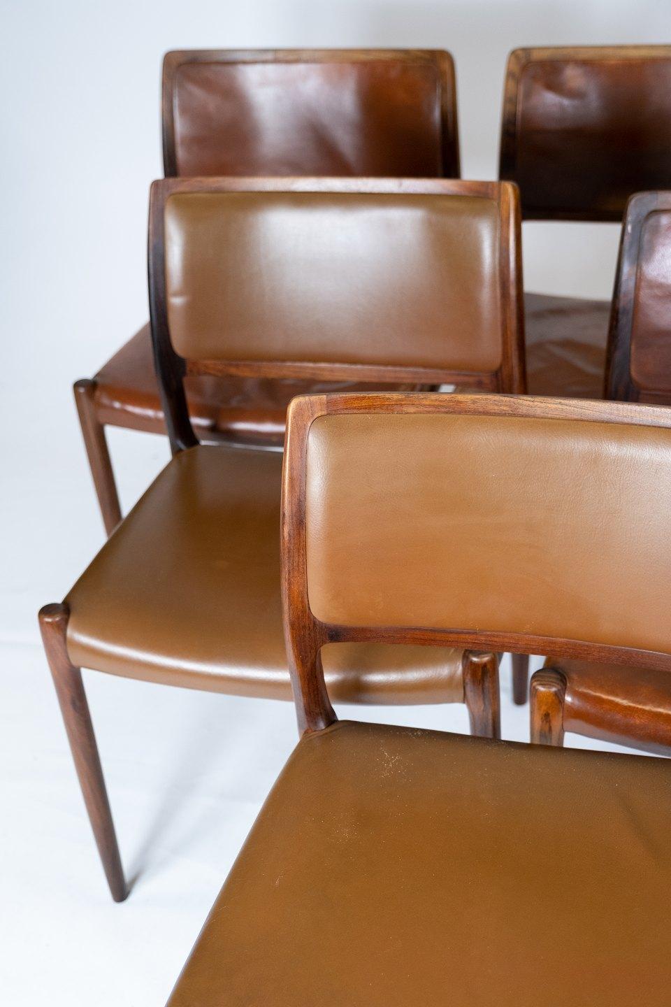 Set of 6 dining chairs, model 80, in rosewood and cognac colored leather designed by N.O. Møller. The chairs in are in great vintage condition and from the 1960s.
Measures: H 79 cm, W 50 cm, D 45 cm and SH 45 cm.