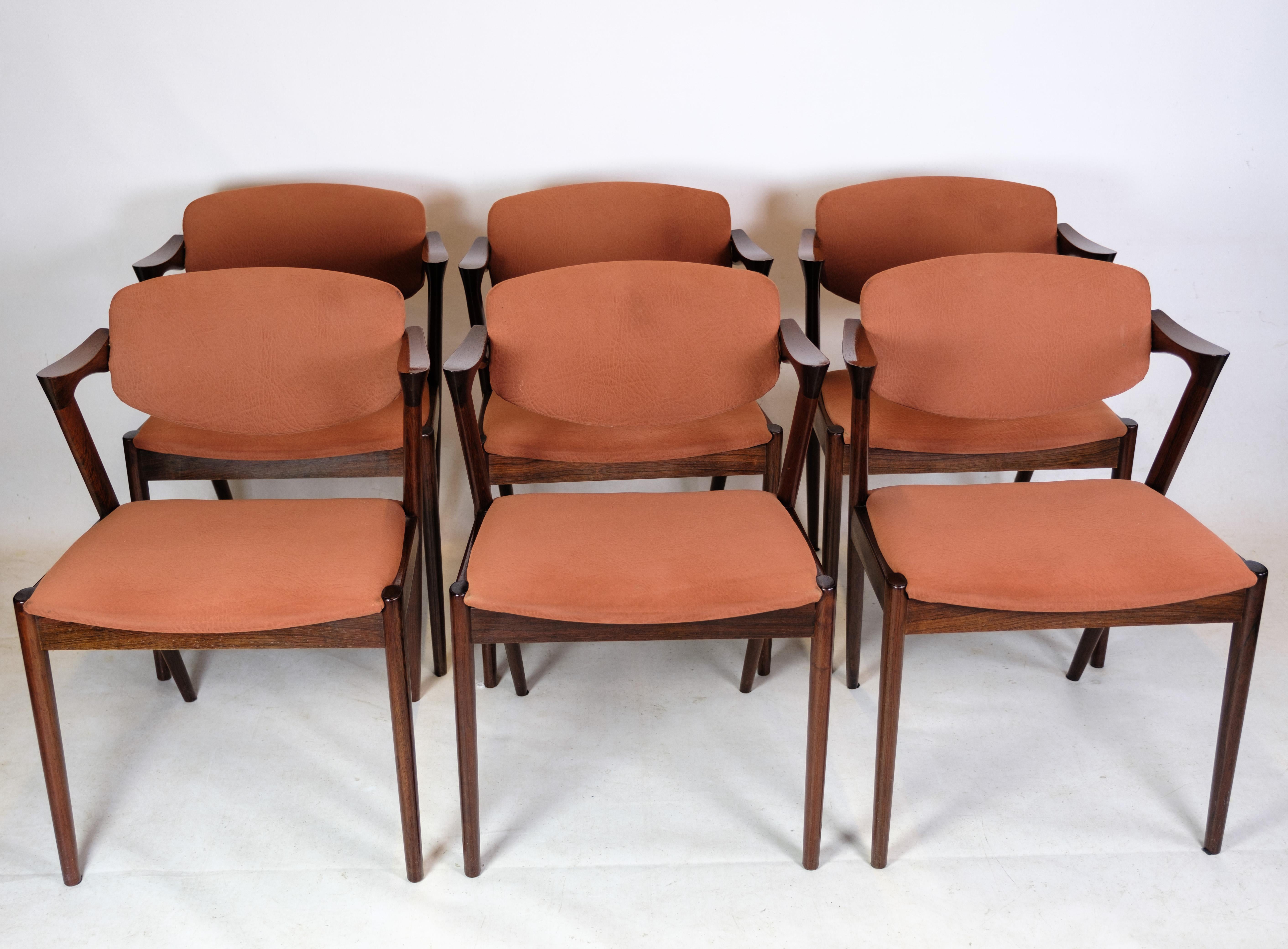 This set of 6 dining chairs is an excellent representation of the timeless and elegant style that characterizes mid-20th century Danish furniture design. The chairs are model 42, designed by the renowned Danish designer Kai Kristiansen and