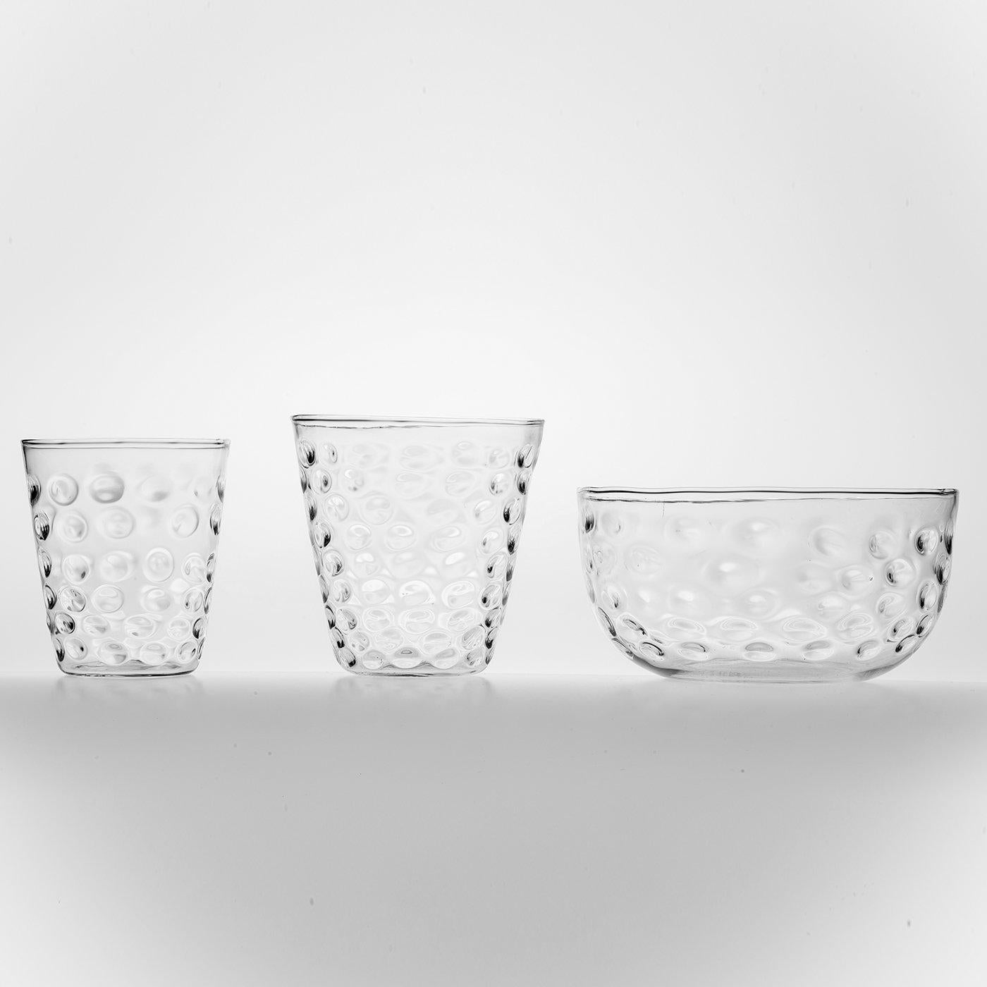 Set of 6 water or wine glasses with an inimitable quality. Handcrafted in Venice, the form of the glasses is finished with a deft bubble effect that creates an elegant interplay of light.