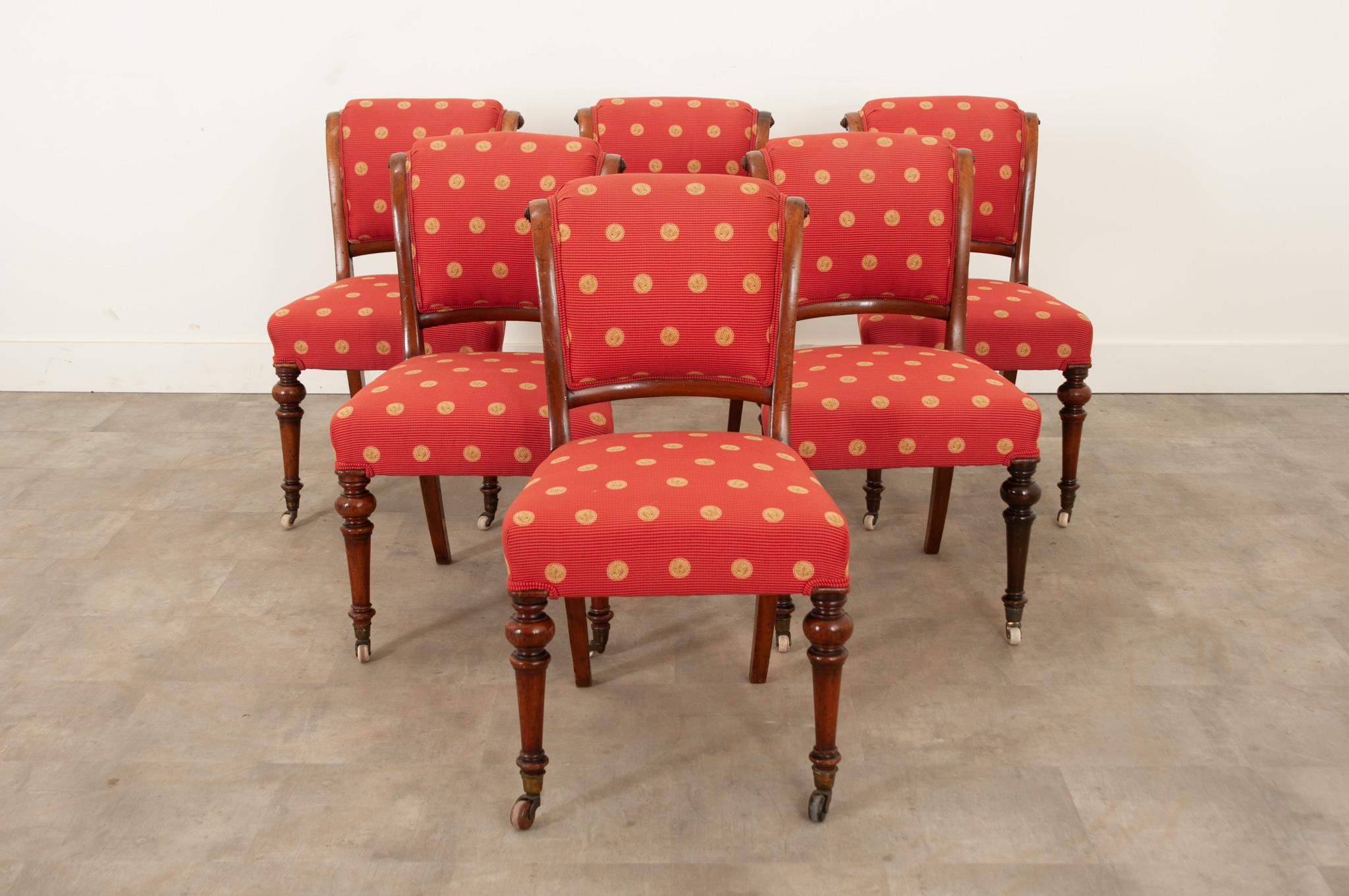 This fantastic set of six mahogany Dutch dining chairs was crafted circa 1850. Upholstered in an eye-catching red striped fabric with gold butterflies and double welt edges at the legs. The back support has a wonderful curve to it and continues to