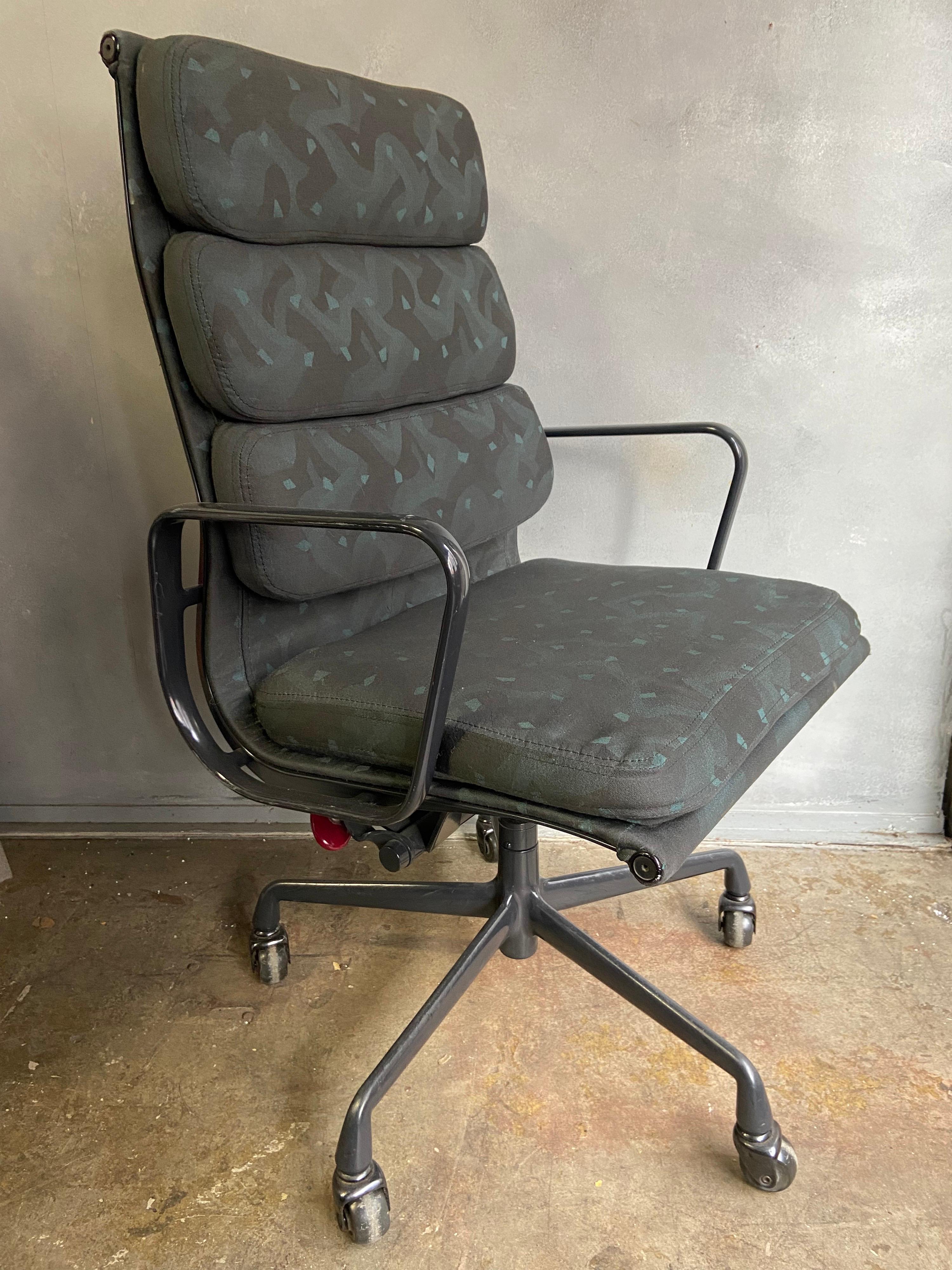 Are rare find of 1980's Soft Pad chairs with high backs from the 1980's. These chairs have a strong Memphis Milano look with period fabric and red adjustment knob that can only be found on Eames chairs for a short time. The frames are in an almost
