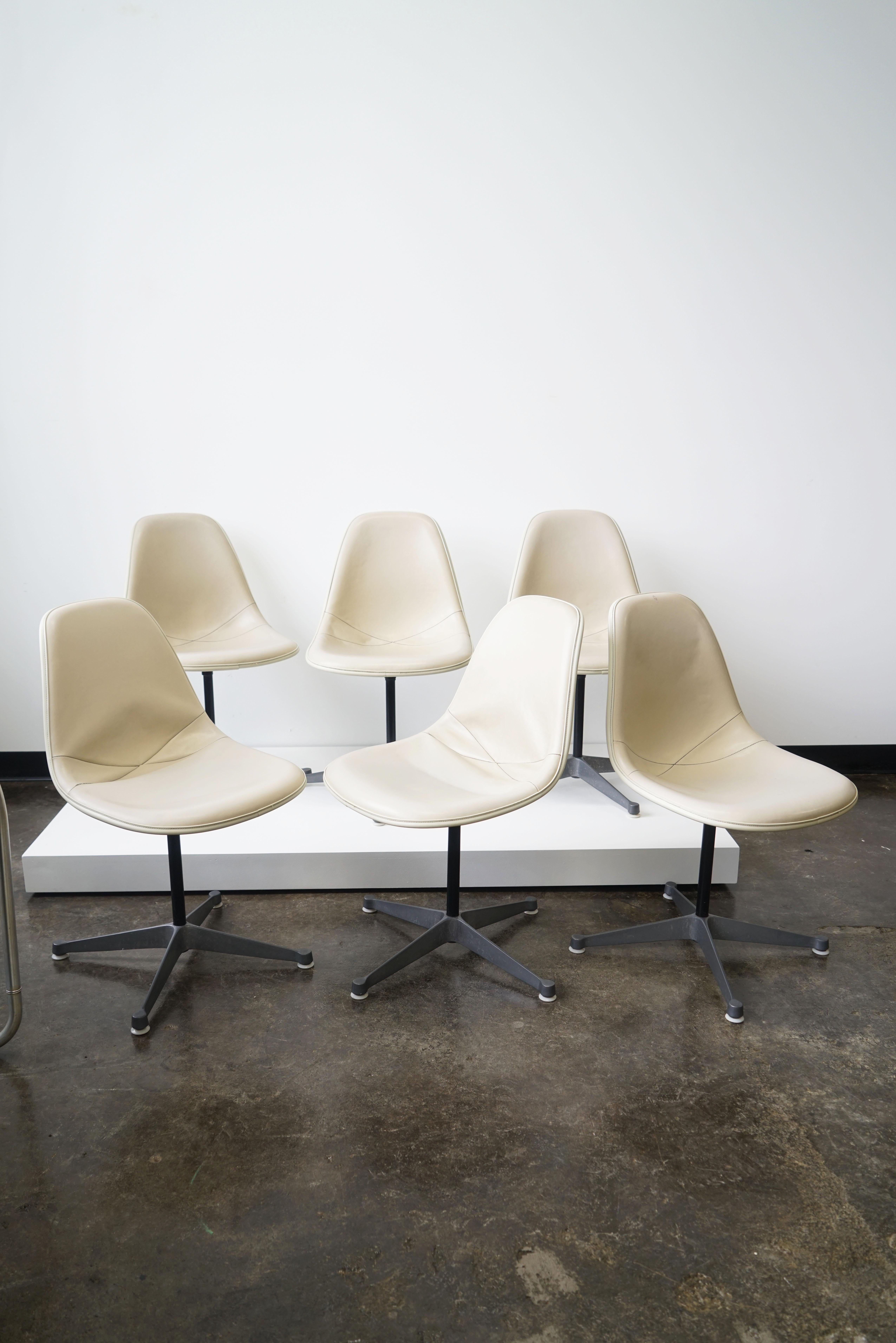 Charles and Ray Eames PSC chairs for Herman Miller
Set of six
circa 1980s
with stitched beige color upholstery.

Manufacturers stamp on underside of shell.

Pivot (P) side chair (S) on Cast Aluminum Base (C).

Part of the fiberglass series