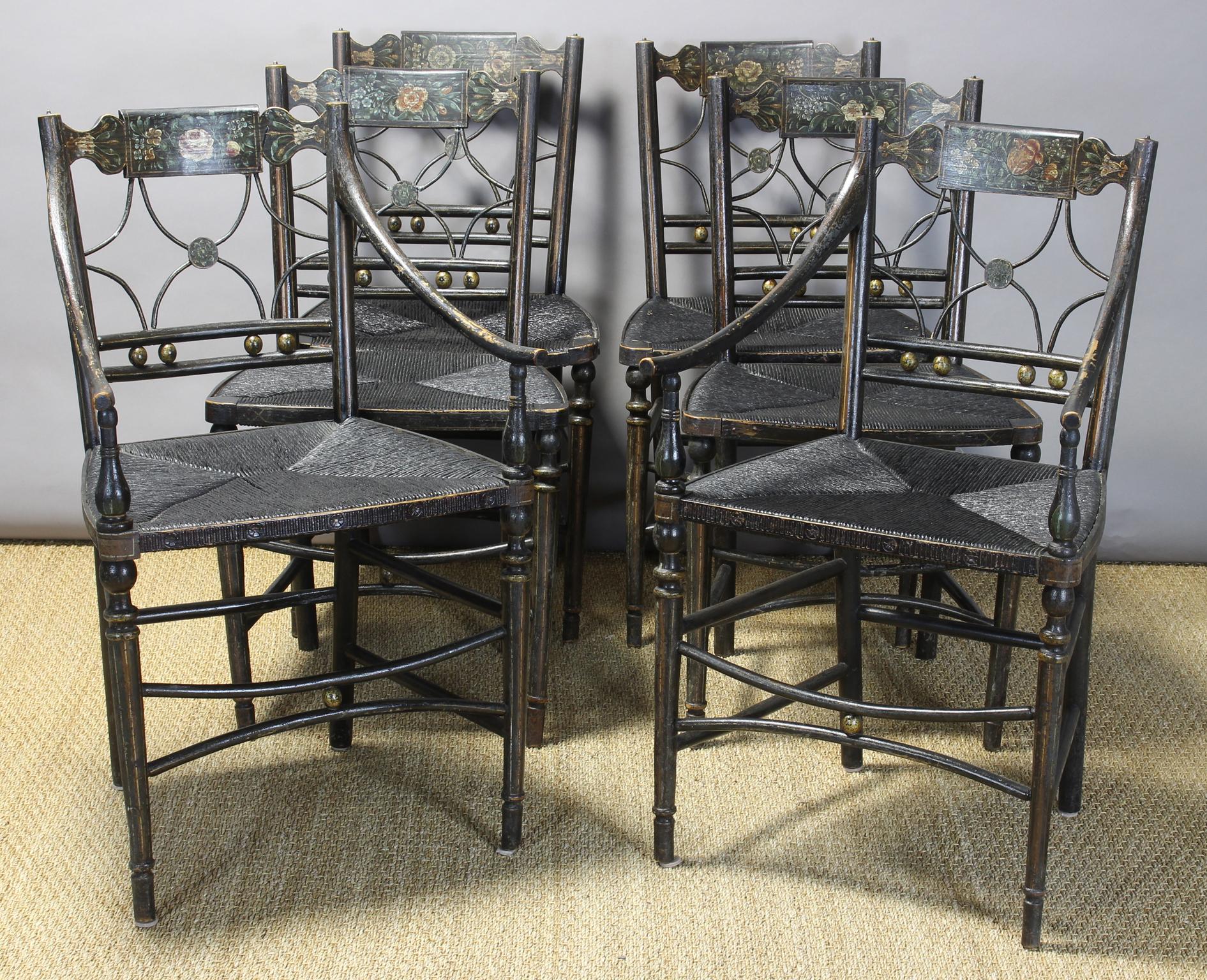 This exceptionally charming early 19th century American dining chairs are finely developed throughout with elegant lines, sturdy construction and beautiful paint and gilt decoration. Each crest rail is beautifully embellished with a unique hand