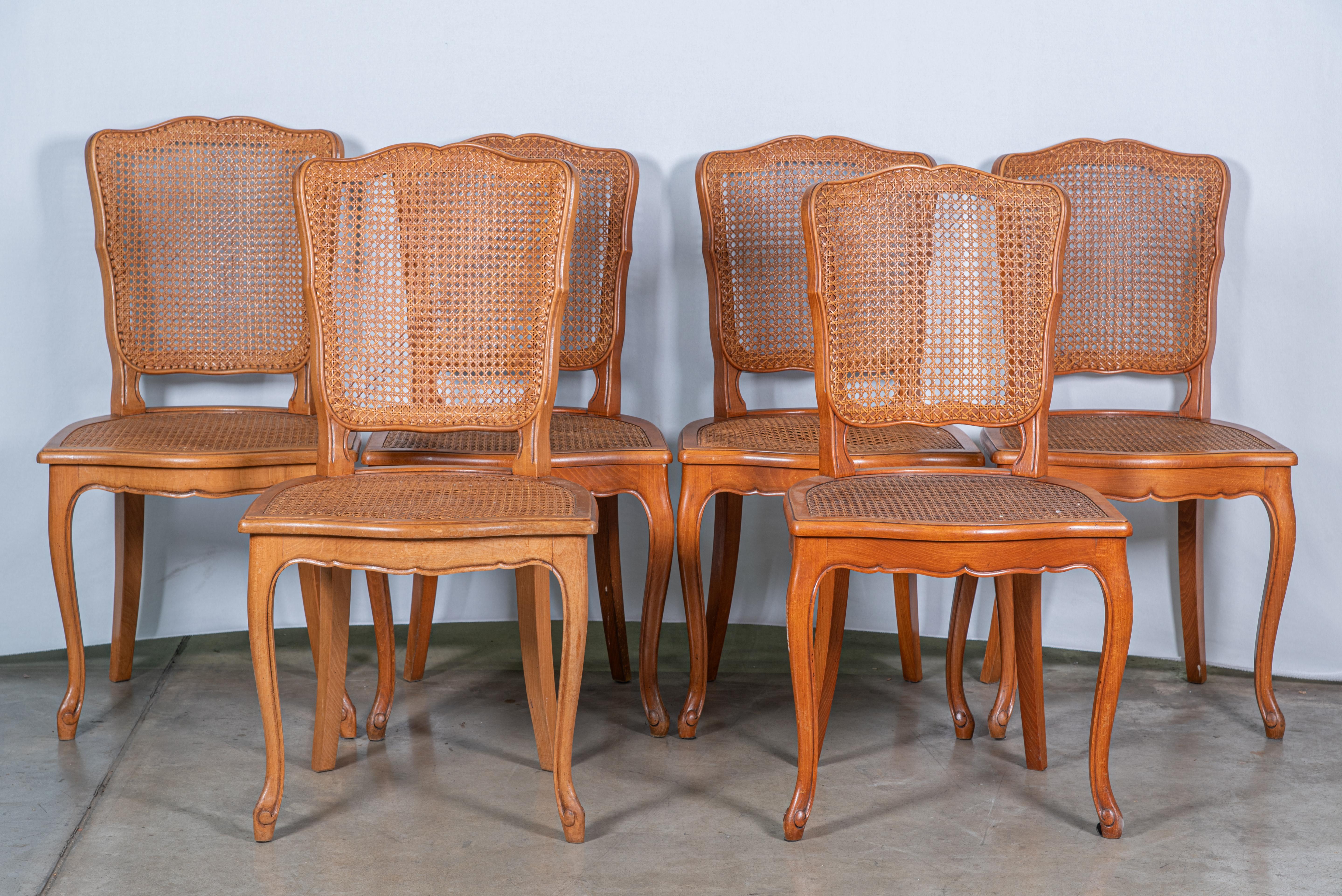 Elevate your dining experience with our captivating Set of Six Early 20th Century French Louis XIV Caned Dining Chairs. Crafted in the distinguished Louis XIV style, these chairs exude timeless elegance and sophistication. Each chair features
