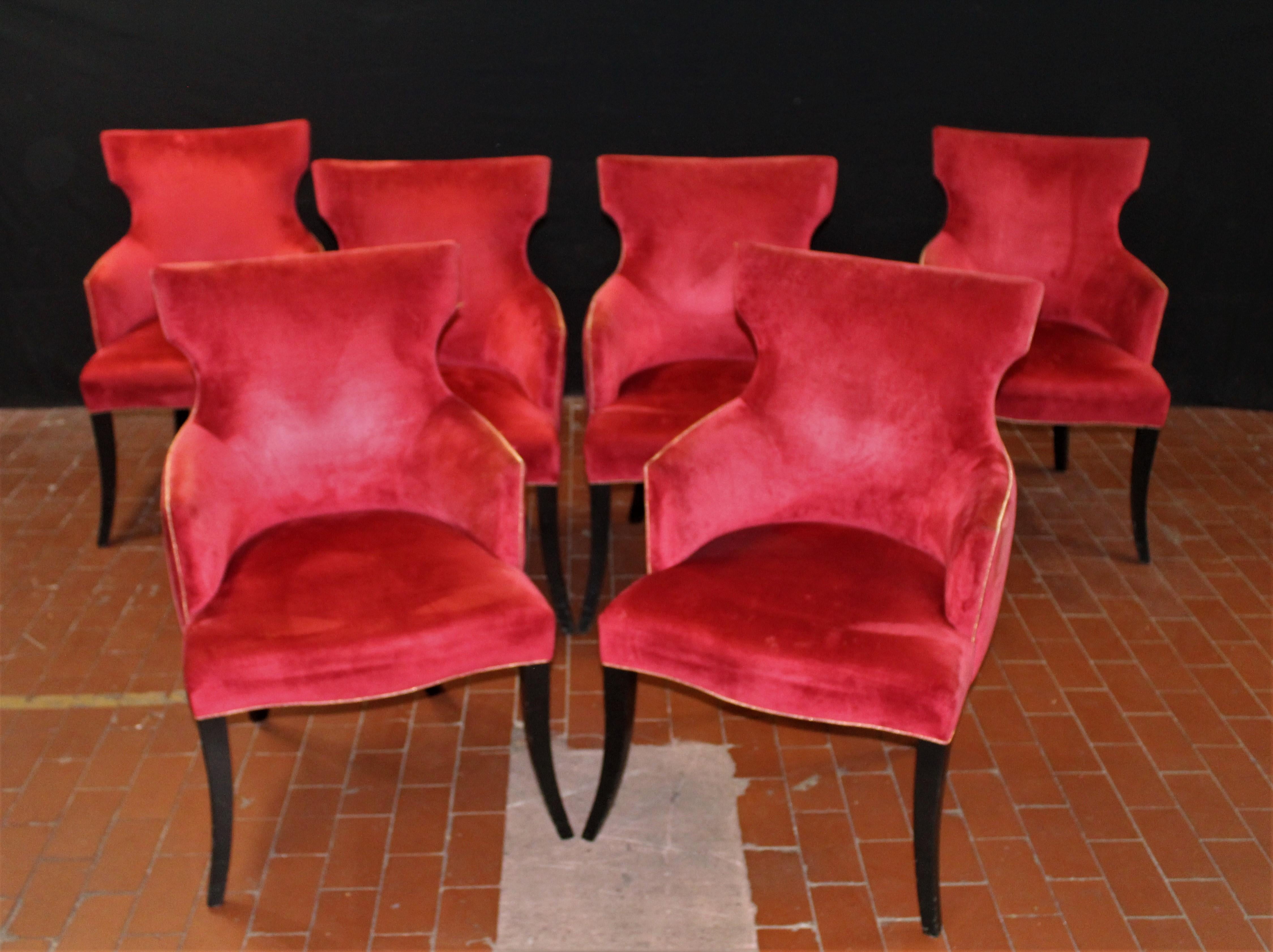 Set of 6 elegant dining chairs in a rich red velvet with gold welt detail on black lacquered cabriolet legs. The arm height is 25