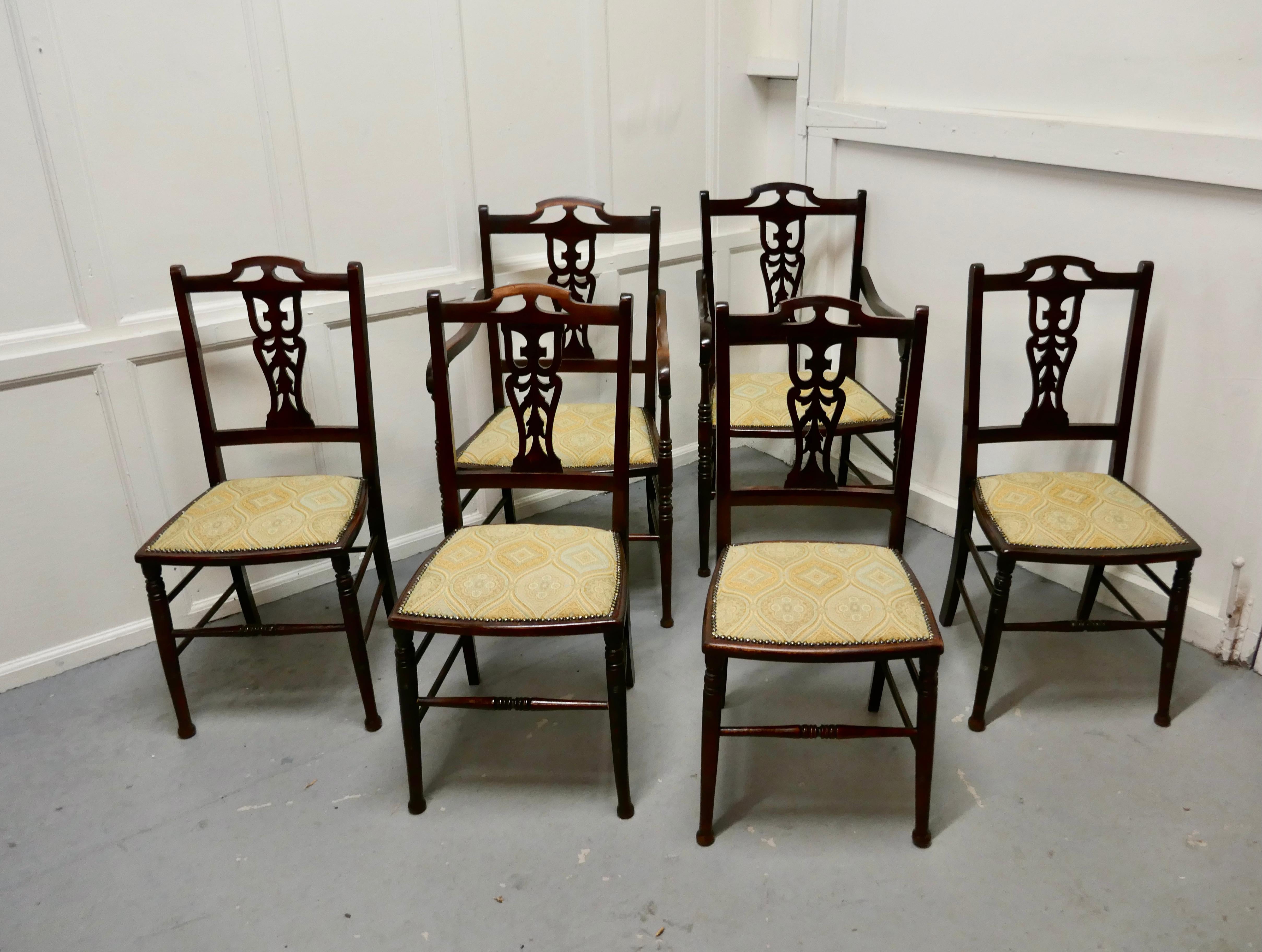 Set of 6 elegant Edwardian upholstered dining chairs 

This is a very handsome set of elegant Edwardian chairs, 2 carver and 4 single chairs they have aesthetic pierced backs with turned legs and stretchers 
The seats have been recently covered,
