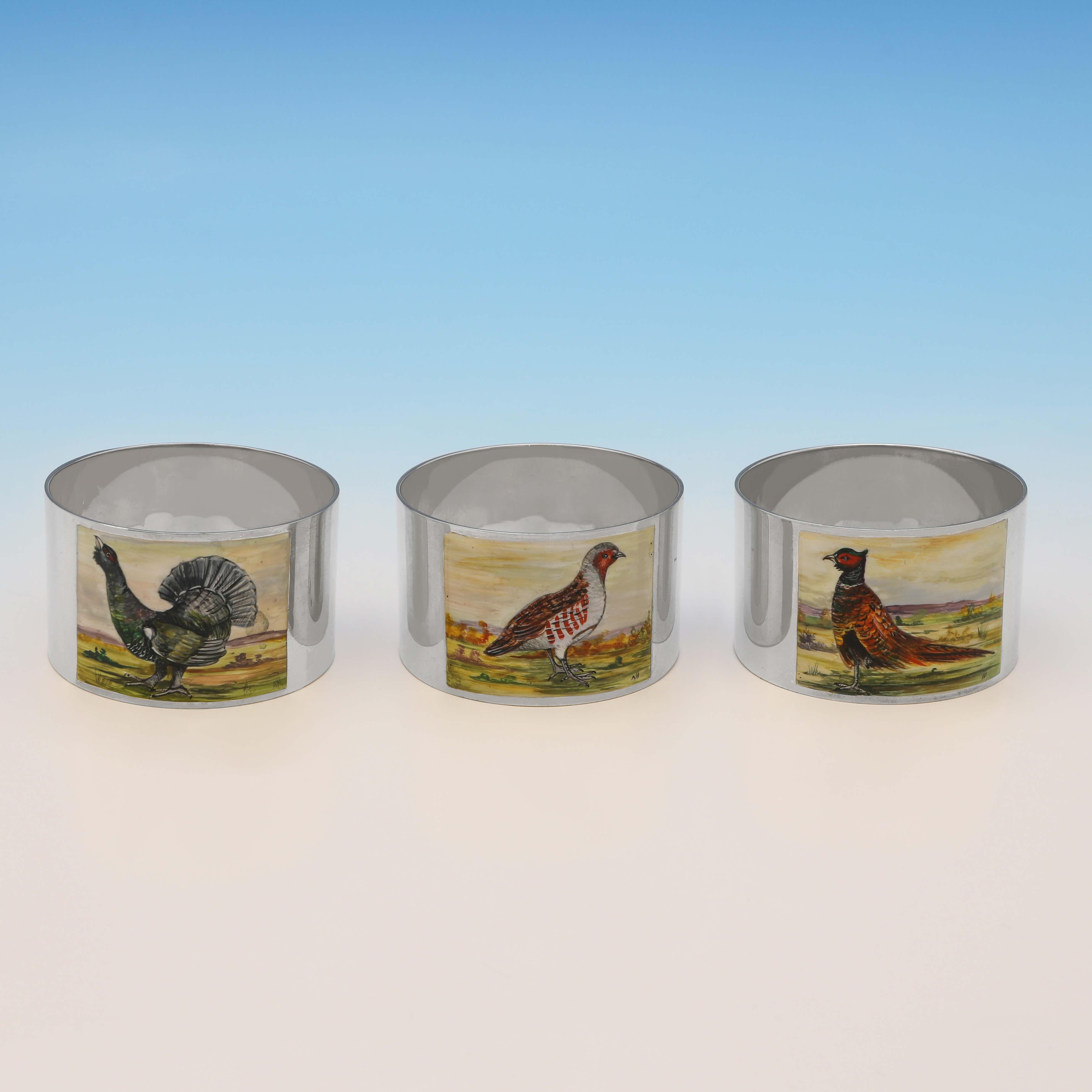 Hallmarked in Birmingham in 1993 by W. I. Broadway & Co., this attractive set of 6 Sterling Silver Napkin Rings, each feature a different enamelled scene depicting game birds. Each napkin ring measures 1