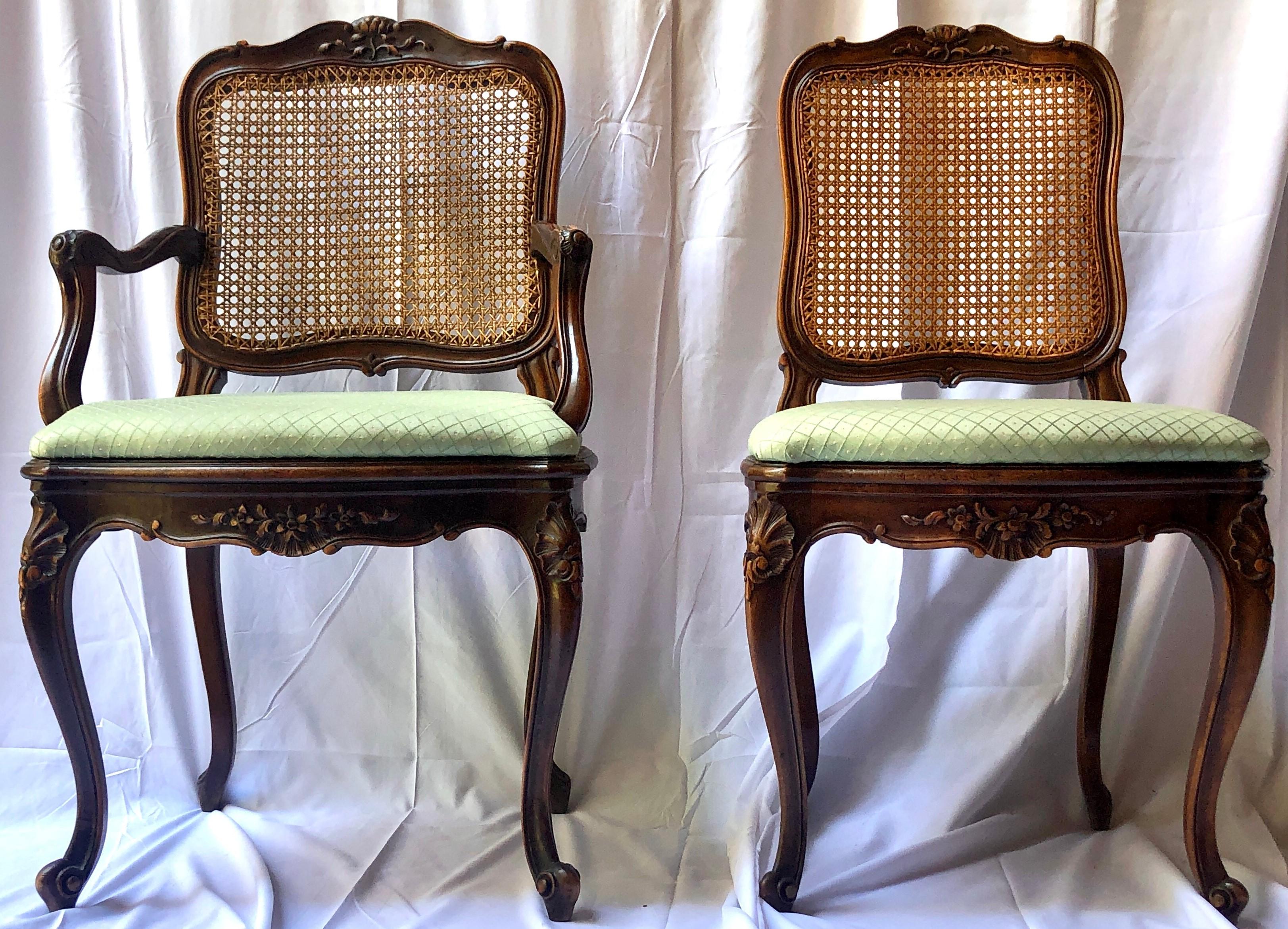 Set of 6 Estate French hand-carved walnut and cane-back dining chairs with green upholstered seats, circa 1940's.
Measures: Arm chair: height - 39 inches, width - 22 1/2 inches, depth - 20 inches
Seat height: 21