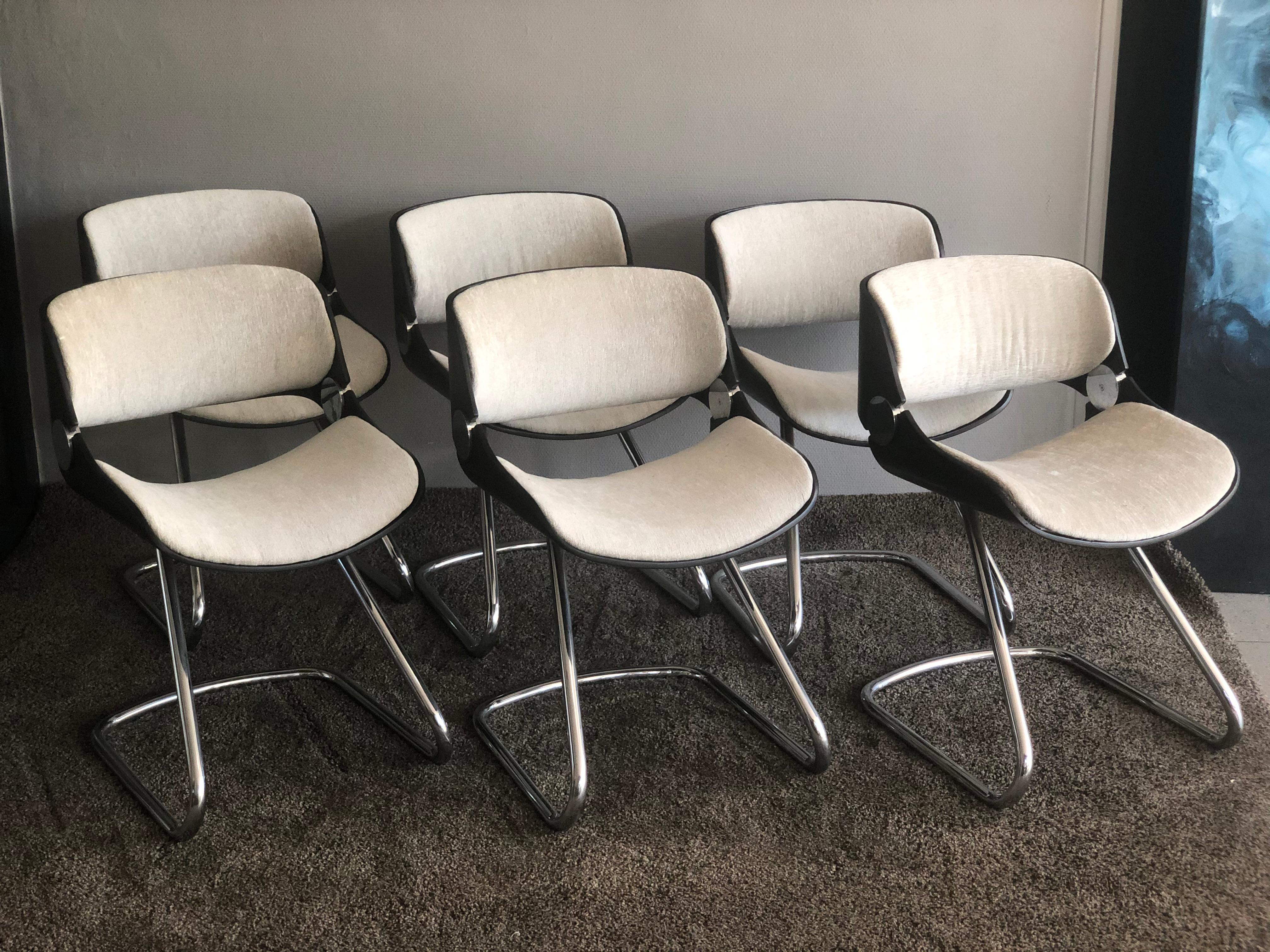 Set of 6 Etienne Fermigier chairs, fully restored in 1970. New fabric, seat in thermofolded wood. Wood hull in good condition and base in non-quilted chrome Dimensions: 73 x 47 x 47 cm.