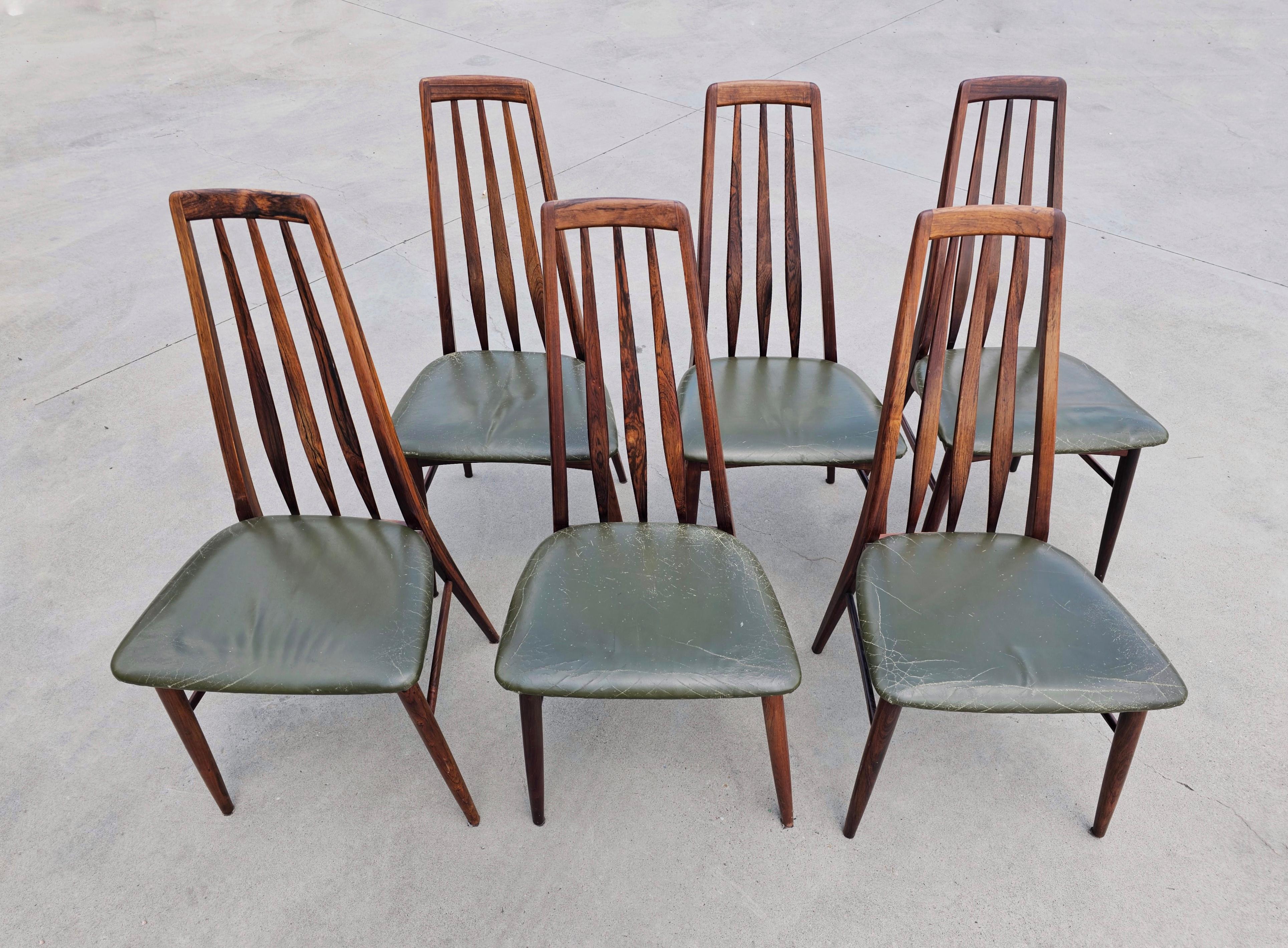 In this listing you will find a set of 6 Mid Century Modern Chairs, Model Eva, designed by Niels Koefoed for his Furniture Factory Hornslet. Chairs are done in Brasilian Rosewood. Seats are still with the original pleather upholstery.

ORIGIN: