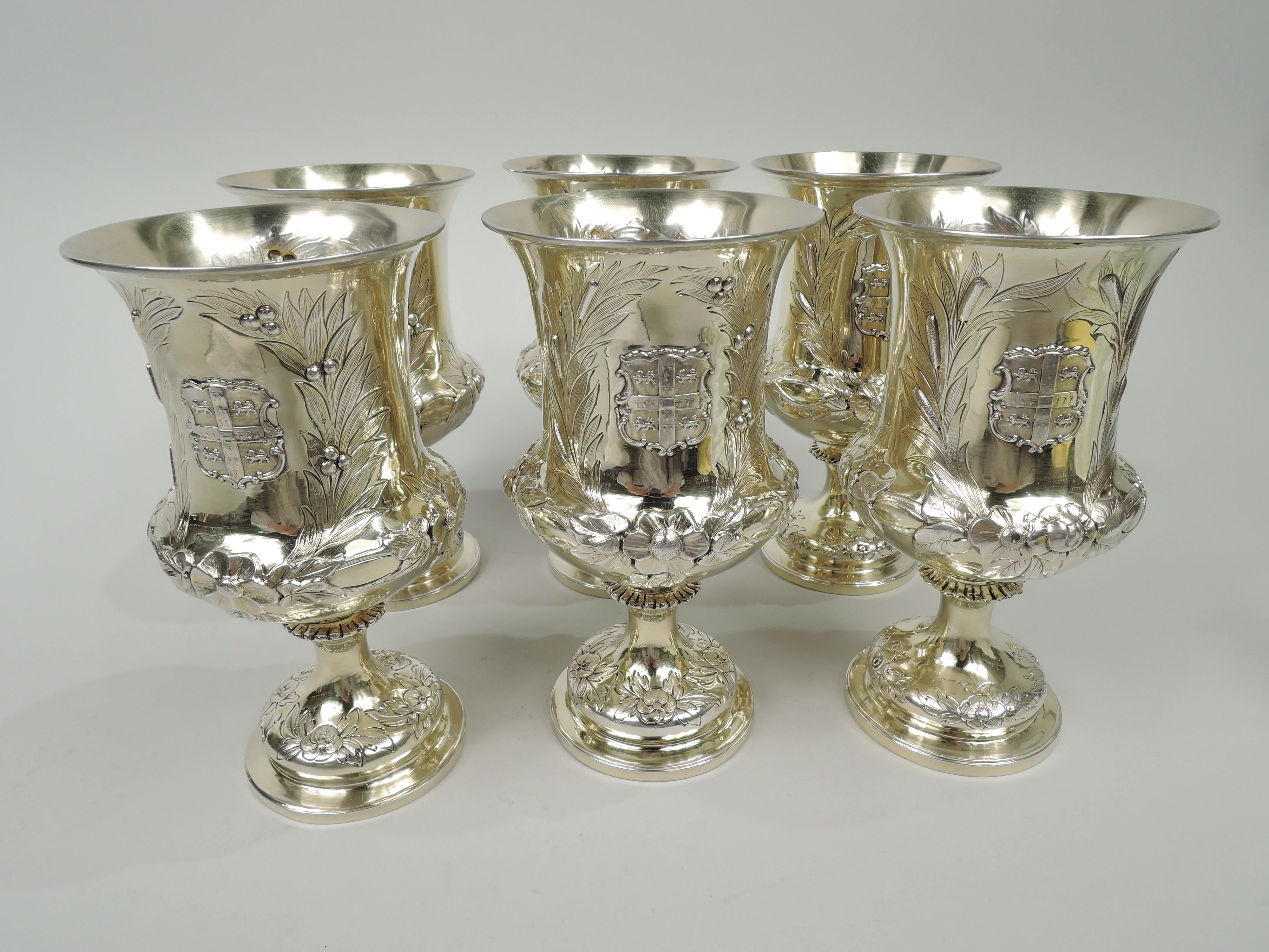 Set of 6 Victorian classical sterling silver goblets. Made by Charles Stuart Harris in London, 1884-9. Medici urn bowl with bellied bottom and flared rim. Spool shaft with flange flowing into raised foot. Chased and engraved garlands and two leaf