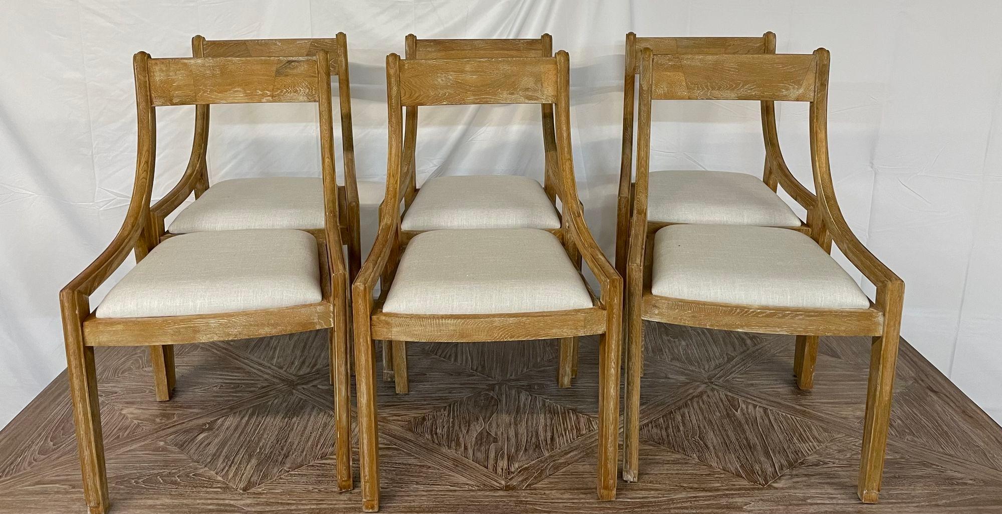 Set of 6 Farmhouse Modern Sleigh back dining / side chairs, pickled wood, linen.
 
Six mid-century inspired French country dining or side chairs having been hand made and produced in the Philippines in 2015. The chairs feature a pickled wood