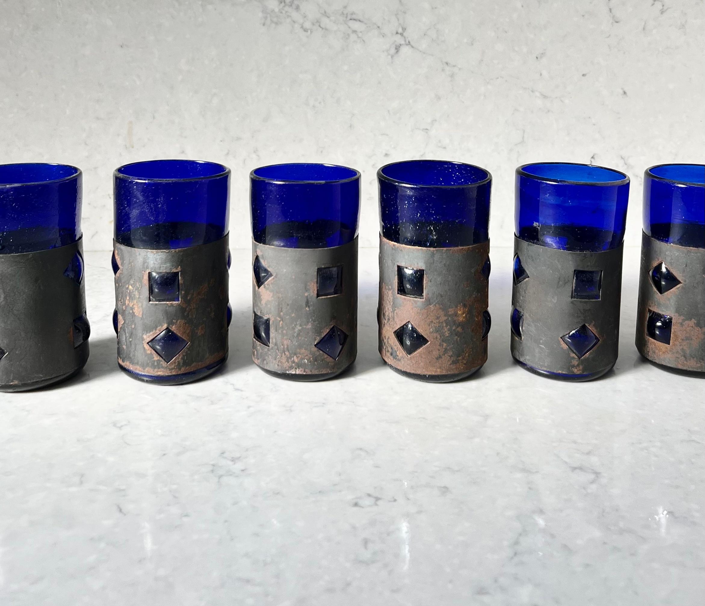 An artisan set of 6 brutalist Felipe Derflingher (aka Delfinger, as it is often mistakenly spelled) for Feders imprisoned cocktail glasses. Yves Klein Blue hand-blown thick art glass with oxidized metal overlays. Circa late 1960s or early 1970s.