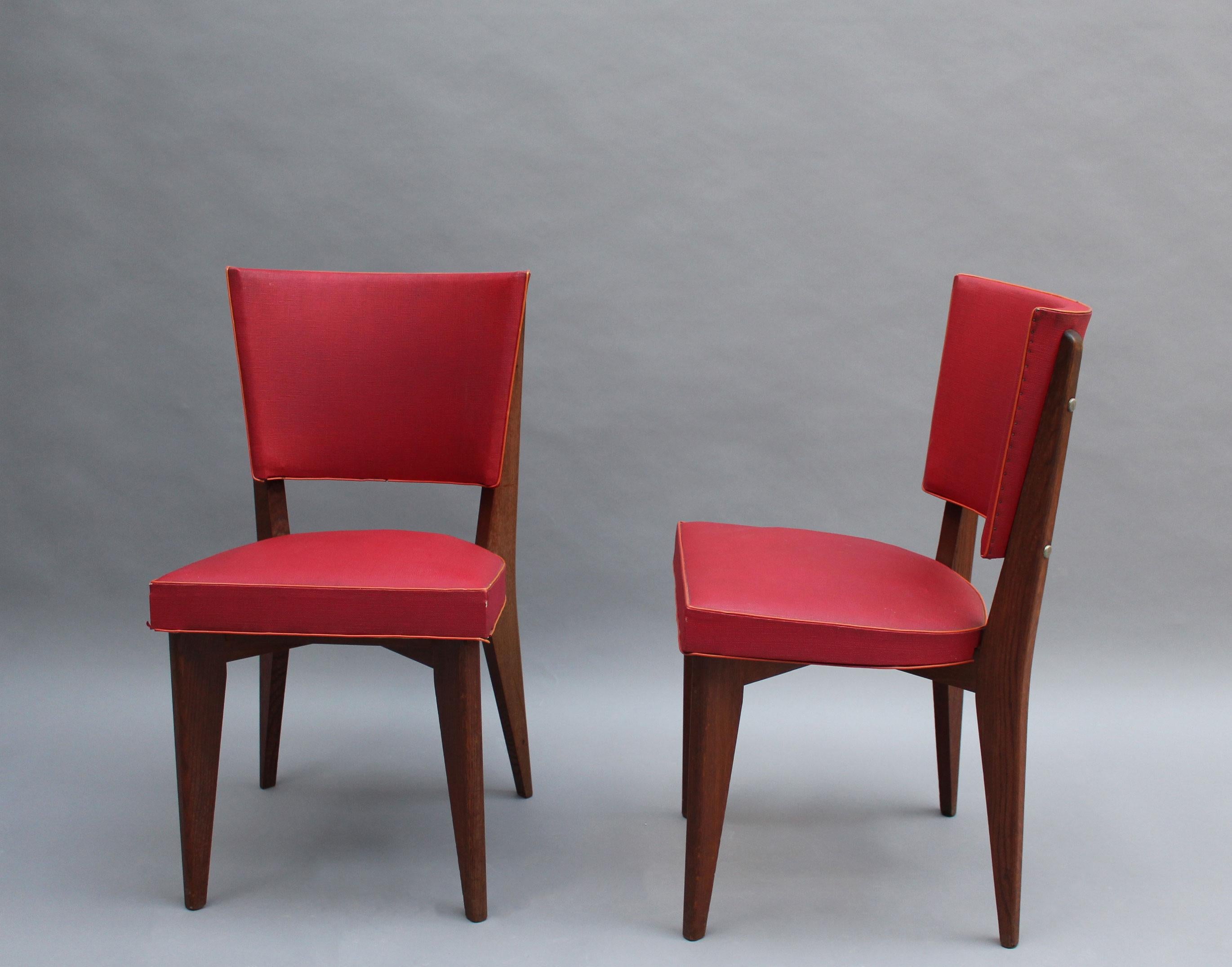 Set of 6 fine French 1950s oak chairs with its original red vinyl upholstery.