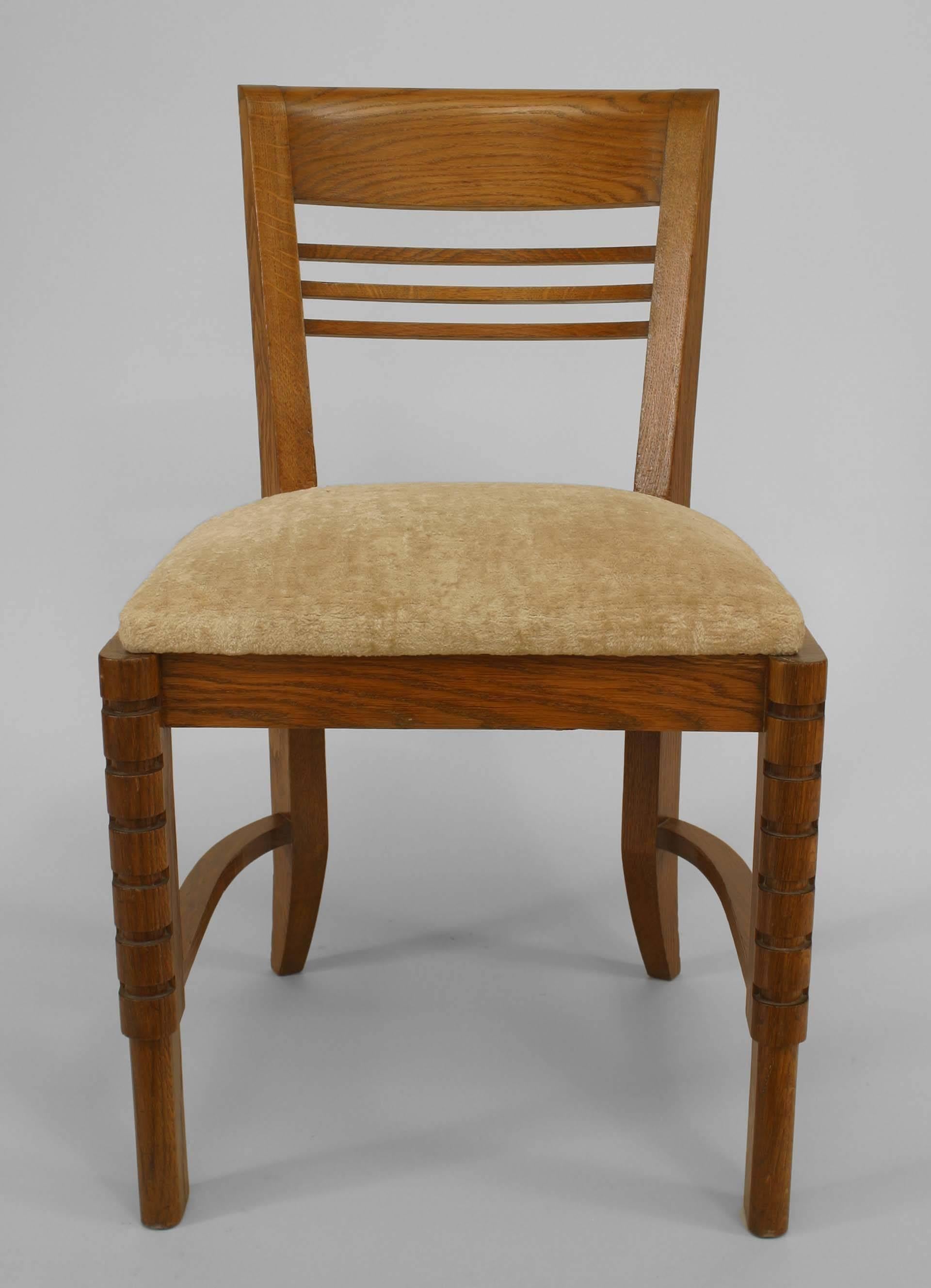 Set of 6 French 1940s oak side chairs with open horizontal slat back design and upholstered seat and notched design on legs.
