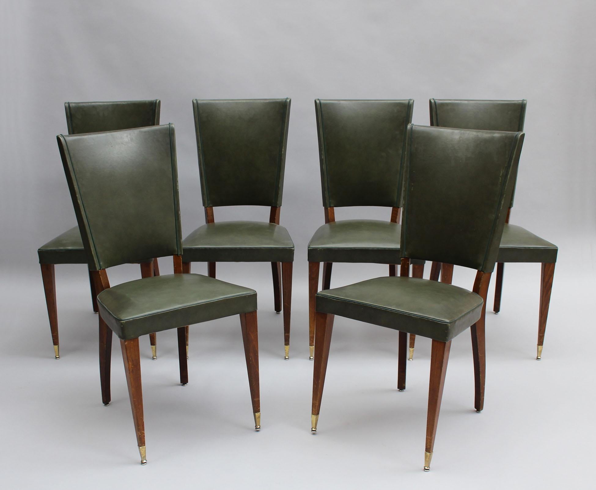 A set of fine French Art Deco dining chairs in stained beech with bronze sabots.