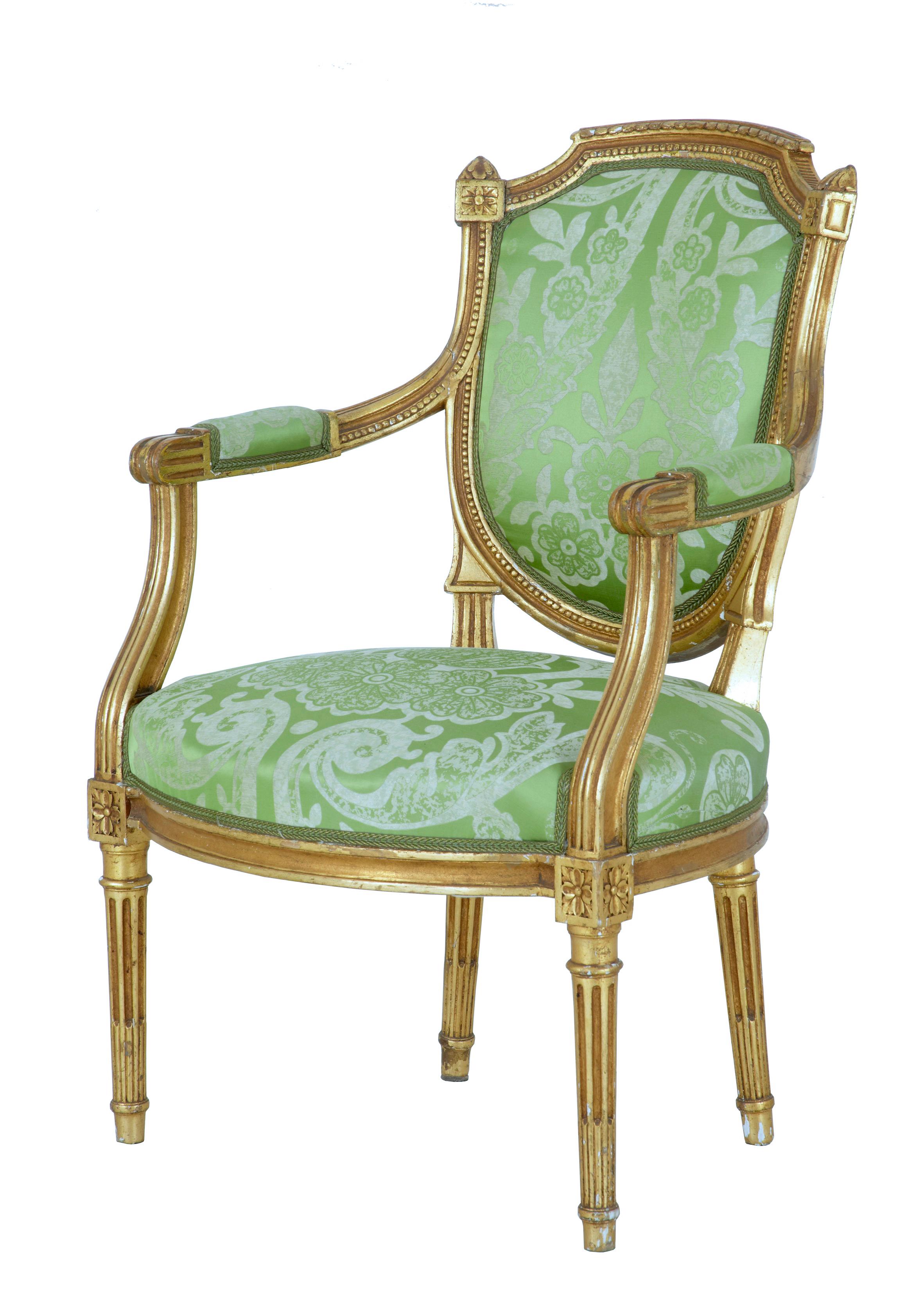 Fine set of French gilt armchairs circa 1880.

Rare to find that these chairs haven't been split up.  Shaped shield back rests with channelled and beaded detailing.  Scrolled arms with arm rest pads which link down to the over stuffed seats.  Each