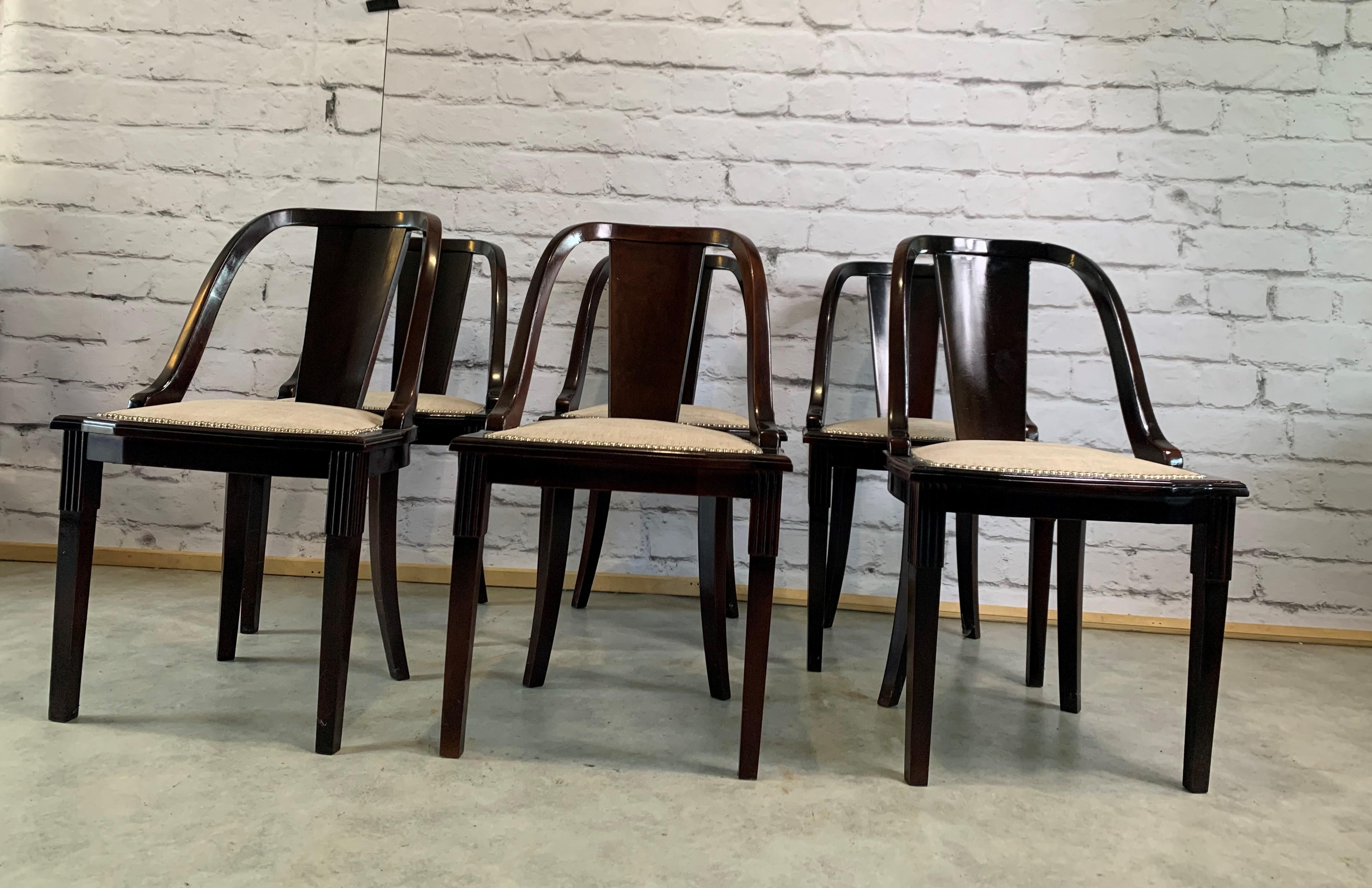 Set of 6 French Art Deco “Gondola” dining chairs, Circa 1930s, made of mahogany, the mahogany wood has been ebonized and finished with a French polished high luster, the seats of 6 dining chairs have been newly upholstered in light beige colour