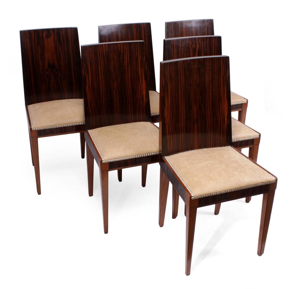 A set of six Art Deco Macassar ebony dining chairs produced in France in the 1930s. The Chairs have a gently curved back with Macassar Ebony front and back, the seat has been fully sprung and upholstered with new thick leather

Measures: H: 90cm