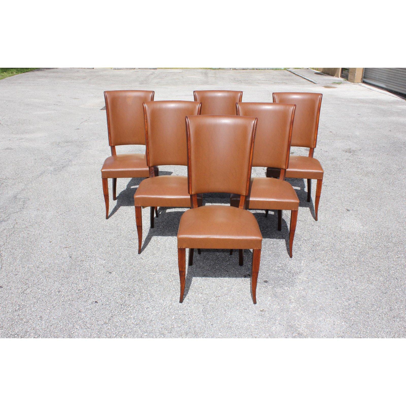 Classic set of six French Art Deco solid mahogany dining chairs 1940s. The chair frames are in excellent condition. Reupholstery is vinyl recommended for all 6 dining chairs, but the color of the dining chairs are beautiful, circa 1940s. Dimensions