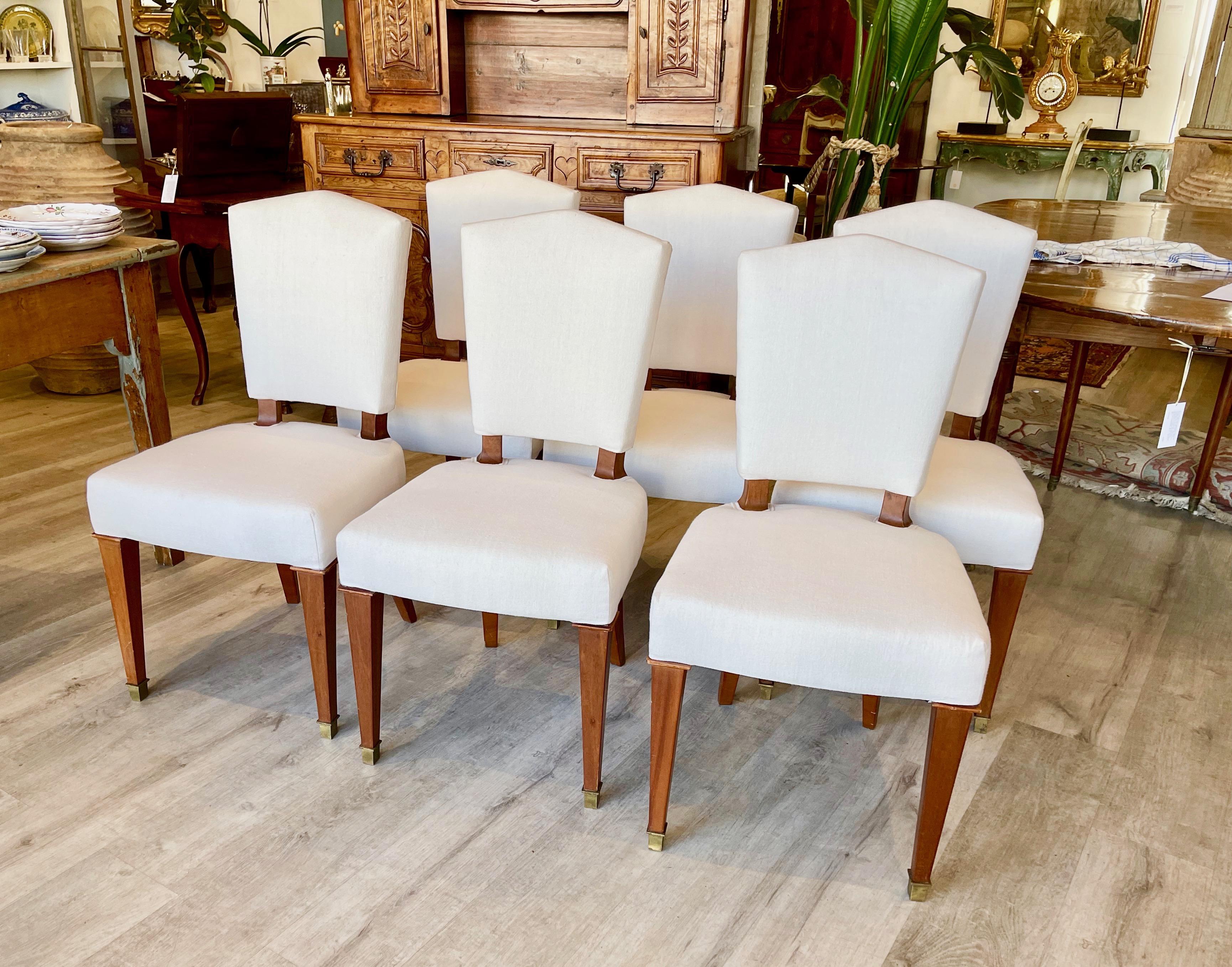 Six French Art Deco mahogany side chairs, circa 1930. From the estate of an important New York modernism dealer. Newly reupholstered in linen.  In excellent, stable condition.