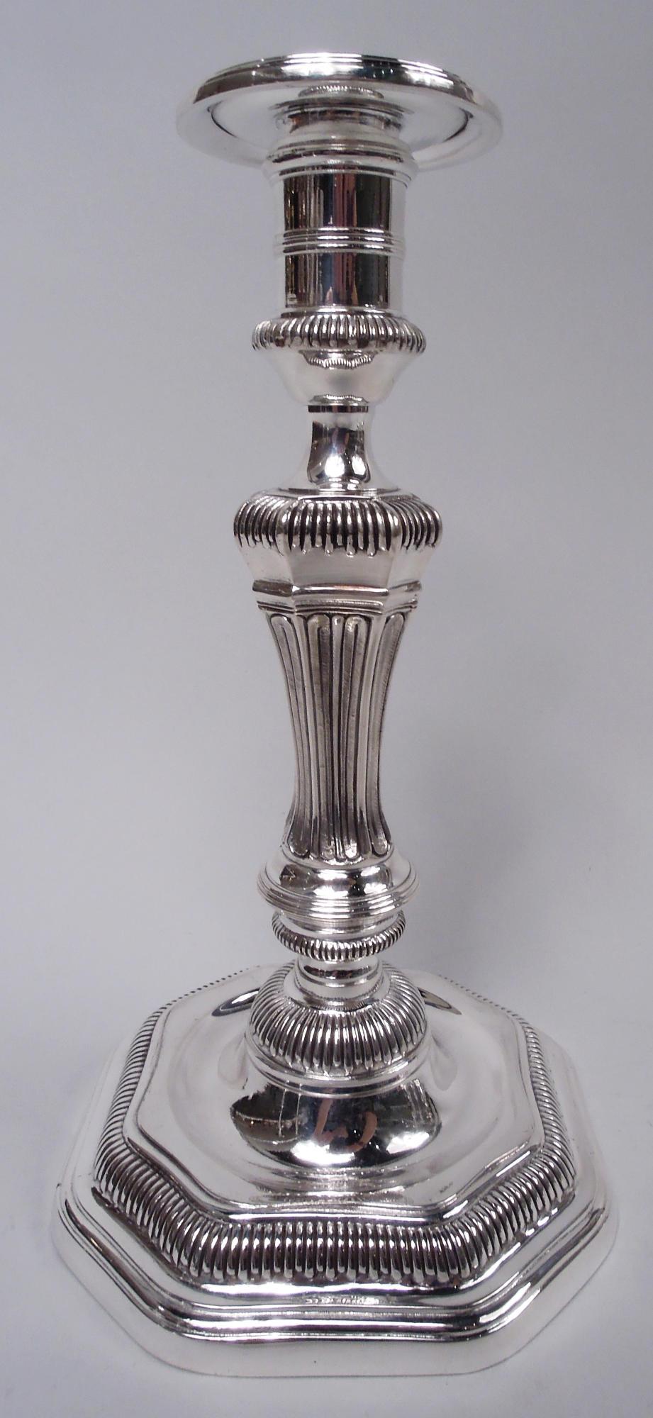 Set of 6 Belle Epoque cast 950 silver candlesticks in Louis XVI style, ca 1910. Made by J. Gruhier in France, ca 1910. Each: Spool socket with stepped and detachable bobeche. Tapering paneled shaft with stippled and elongated egg-and-dart; domed